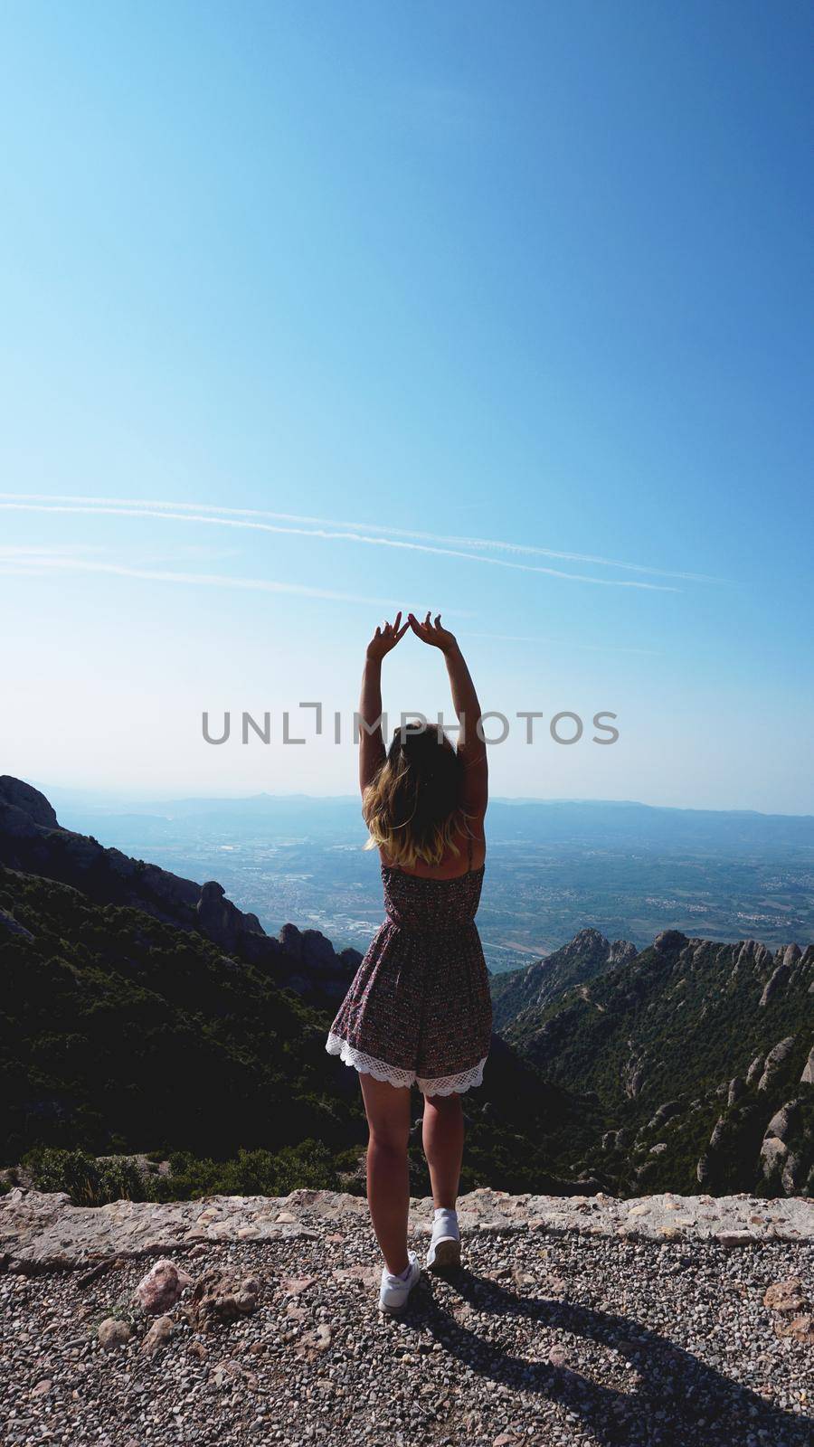 Young happy woman enjoying the magnifisent view of Montserrat Mountains