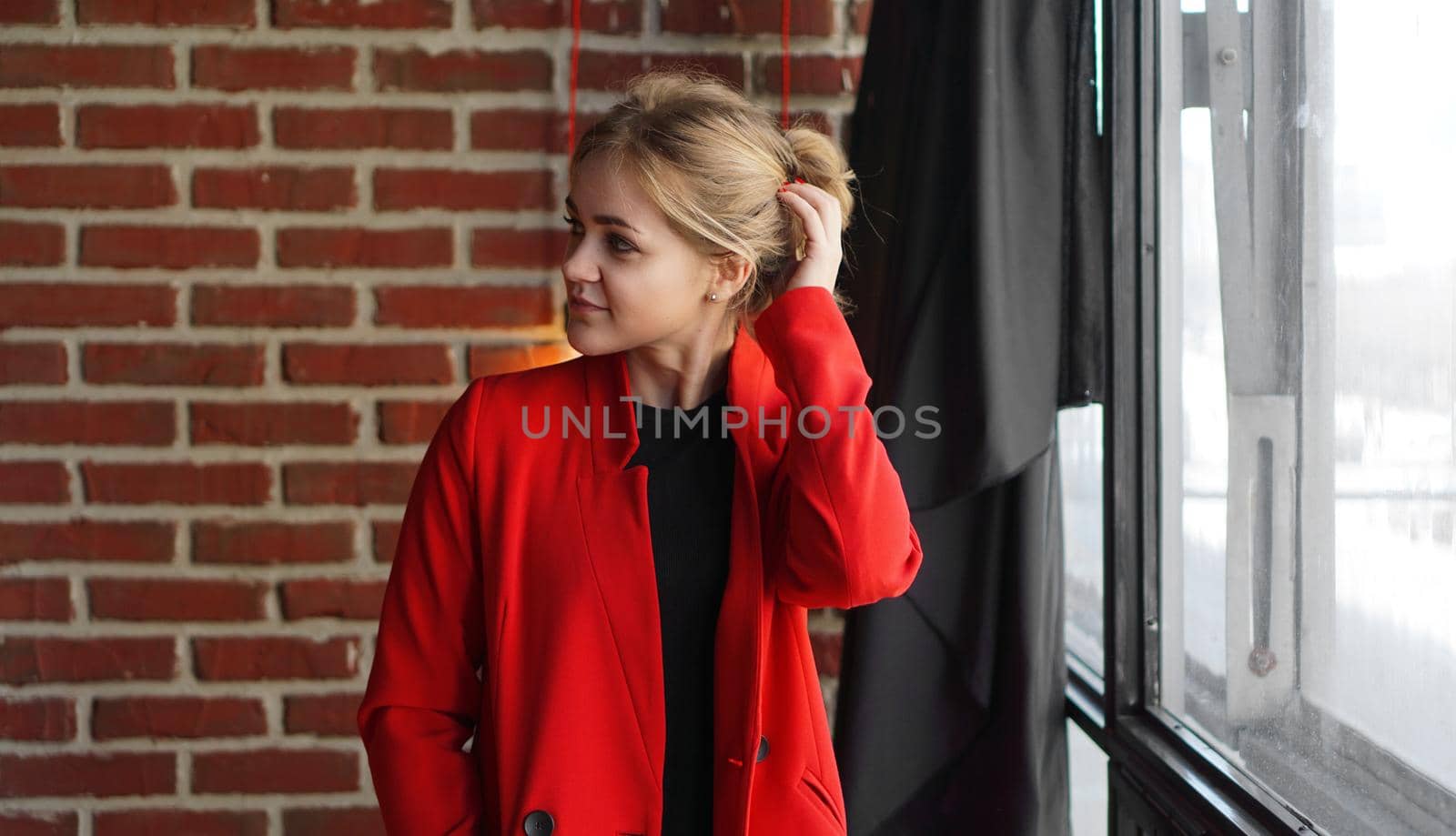 Businesswoman happy smile wear red jacket - business woman over office brick wall