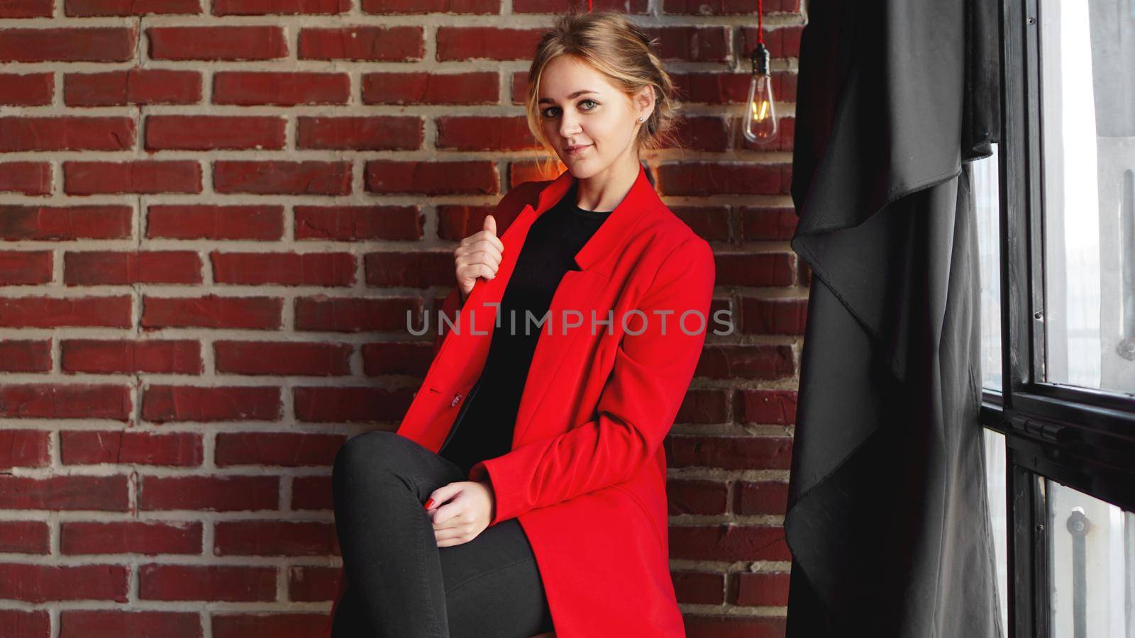 Businesswoman happy smile wear red jacket over office brick wall by natali_brill