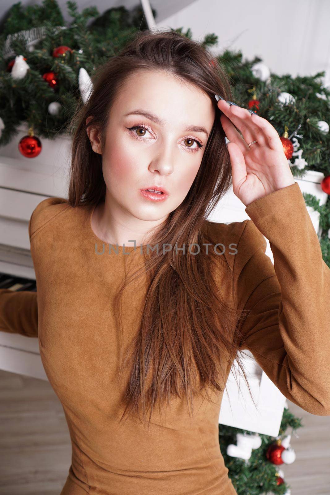 Girl near a white grand piano with christmas decor by natali_brill