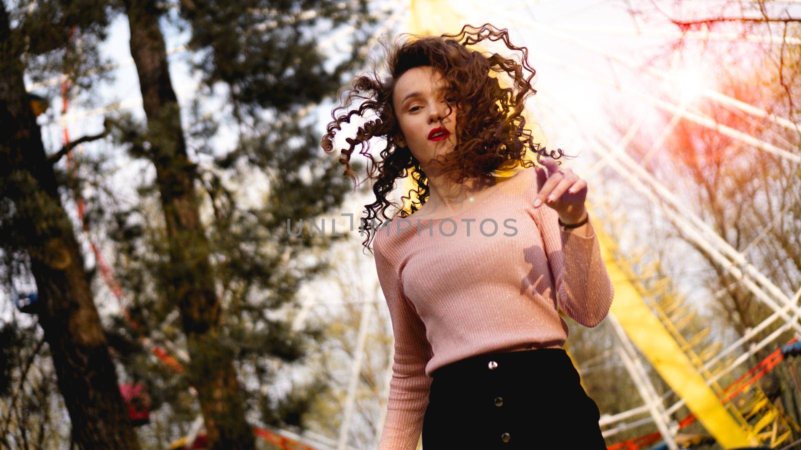 Beautiful exited smiling woman having fun at amusement park at hot summer day by natali_brill