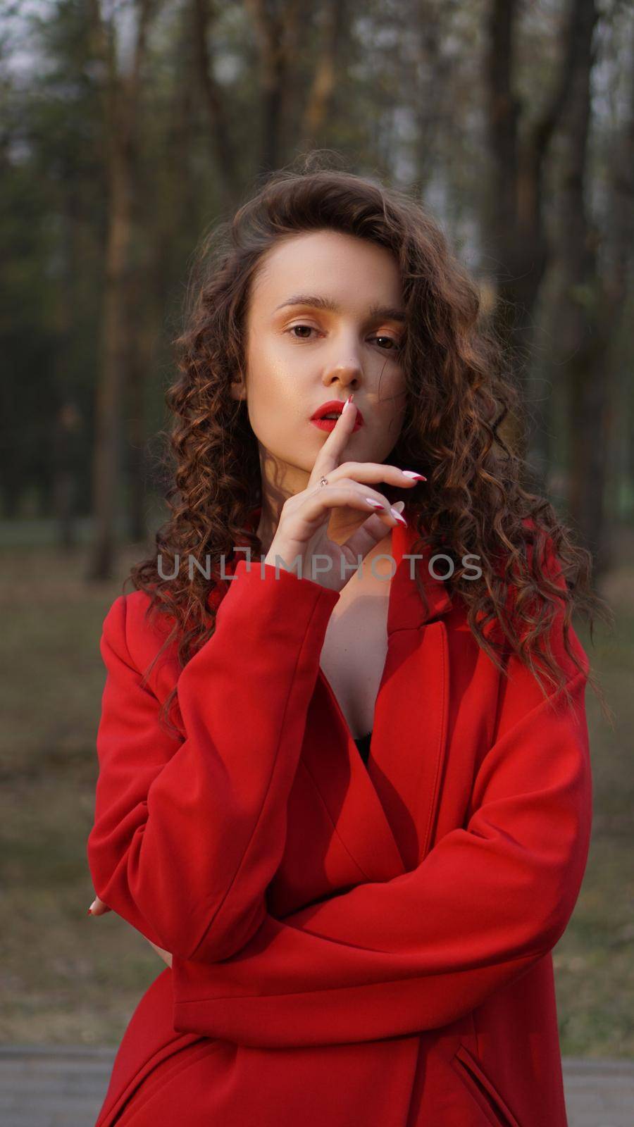 Glamorous woman wearing red outfit and matching red lip gloss. by natali_brill