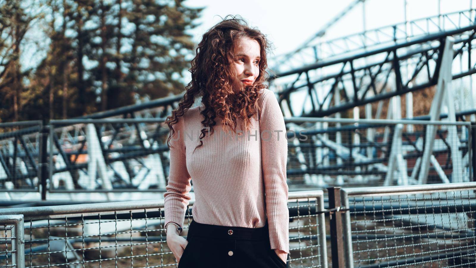 Beautiful smiling girl on a background of a roller coaster by natali_brill