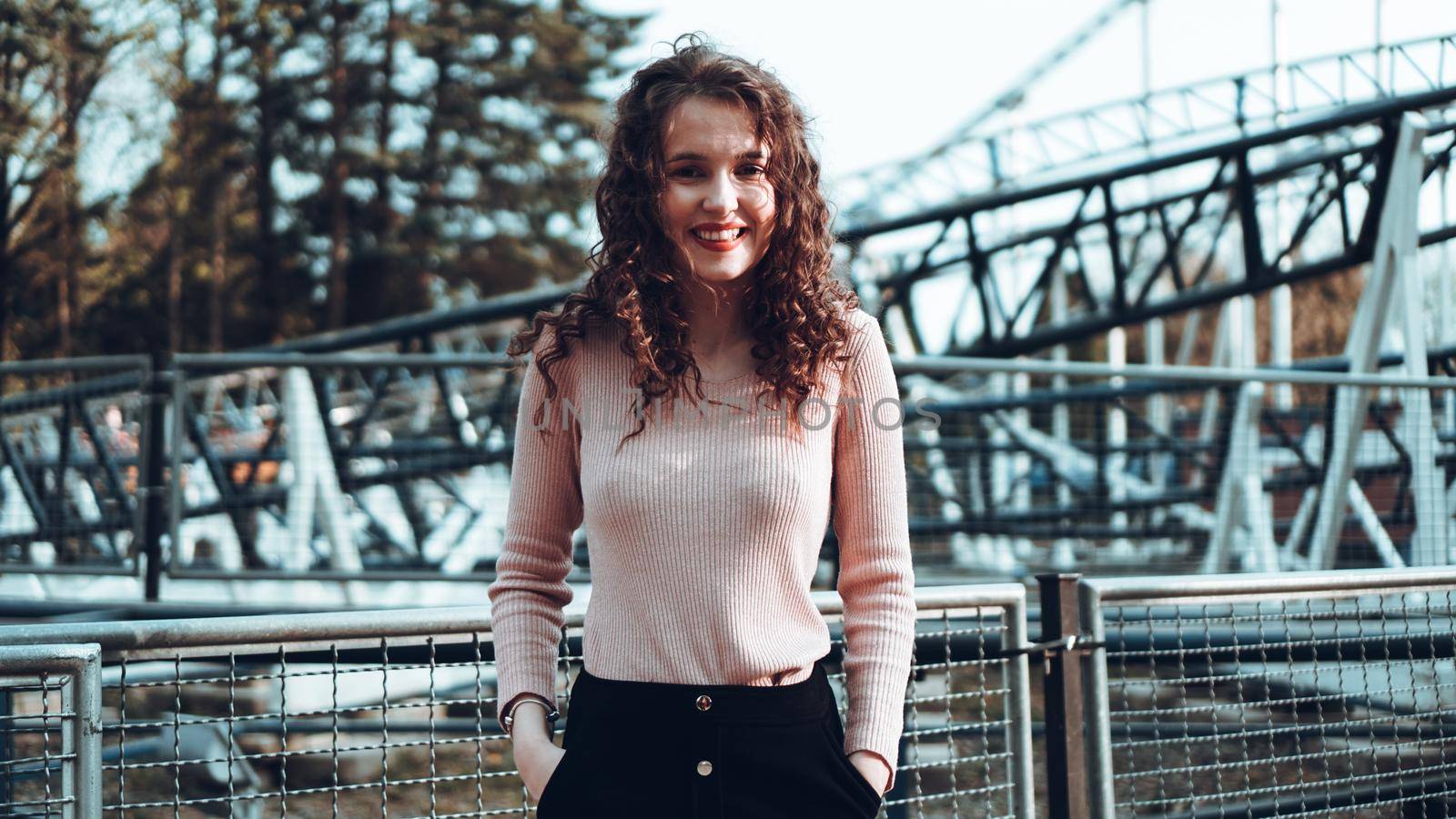 Beautiful smiling girl on a background of a roller coaster by natali_brill