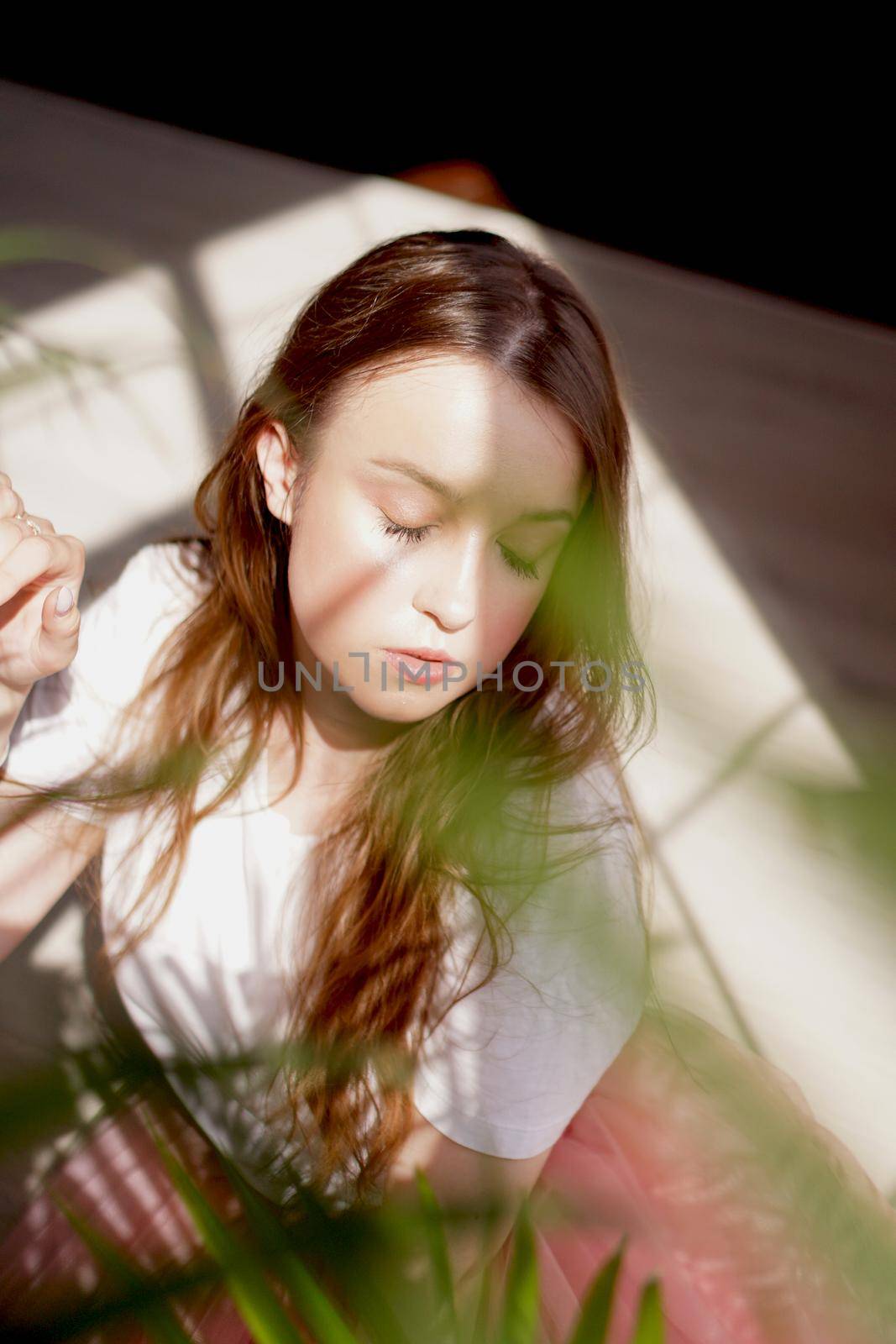 Young beautiful woman with shadows on face - fashion portrait