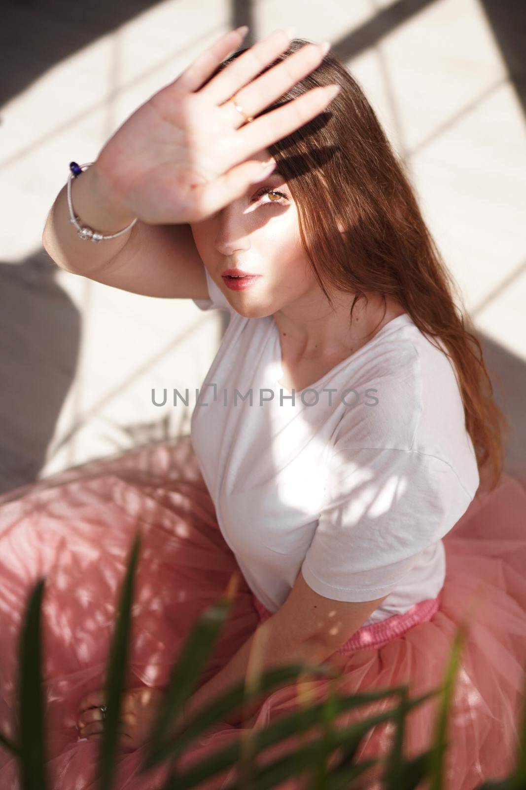 Young beautiful woman with shadows on face - fashion portrait