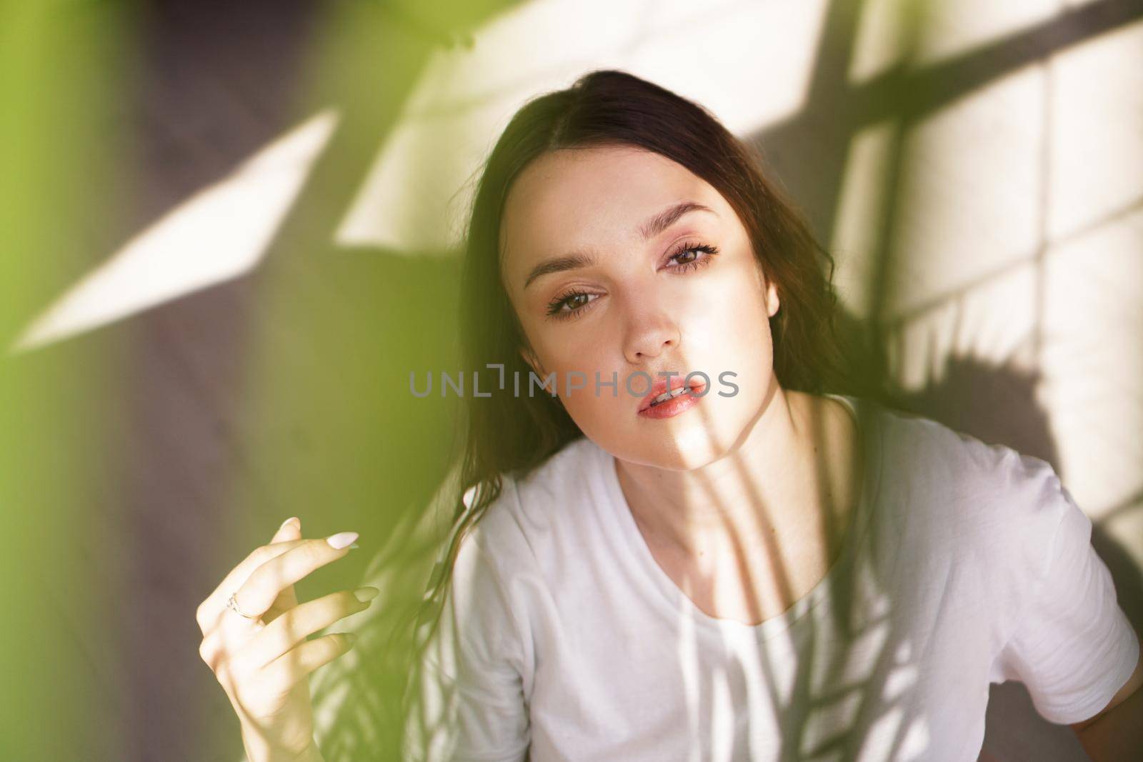 Young beautiful woman with shadows on face - fashion portrait