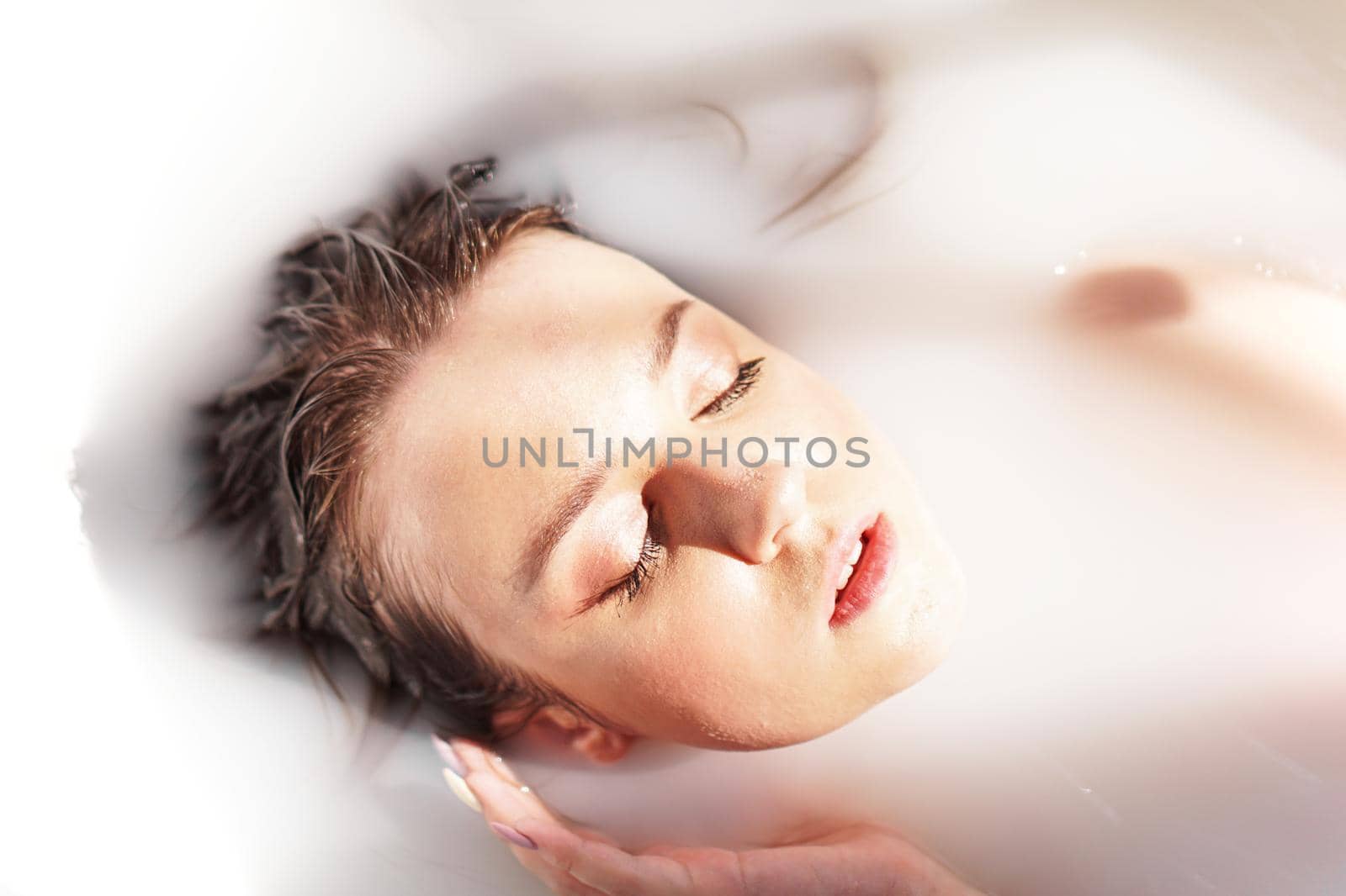 Young attractive woman relaxing in bath - beauty portrait - sunny day