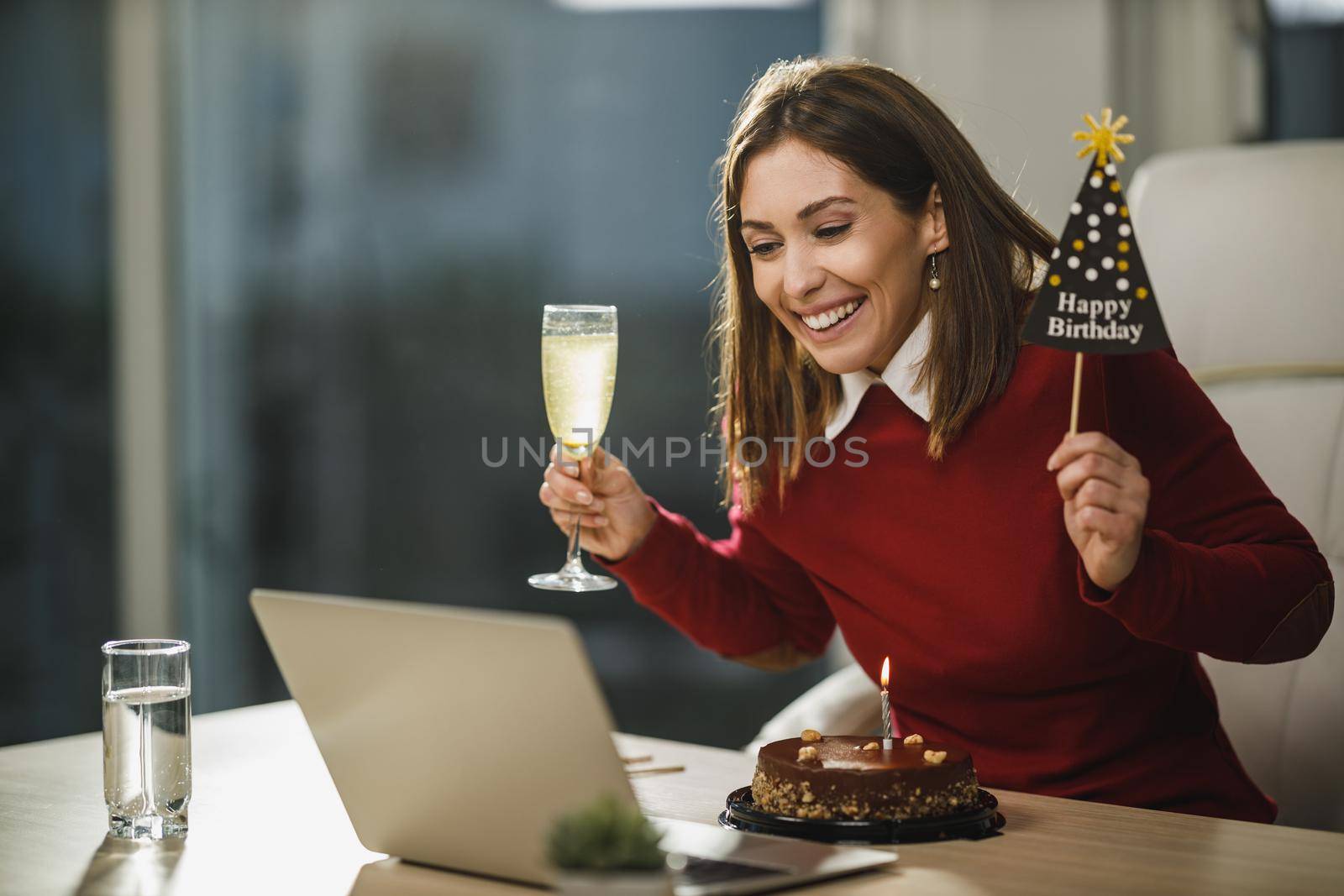Smiling attractive woman have online birthday party with friends during Covid-19 pandemic.