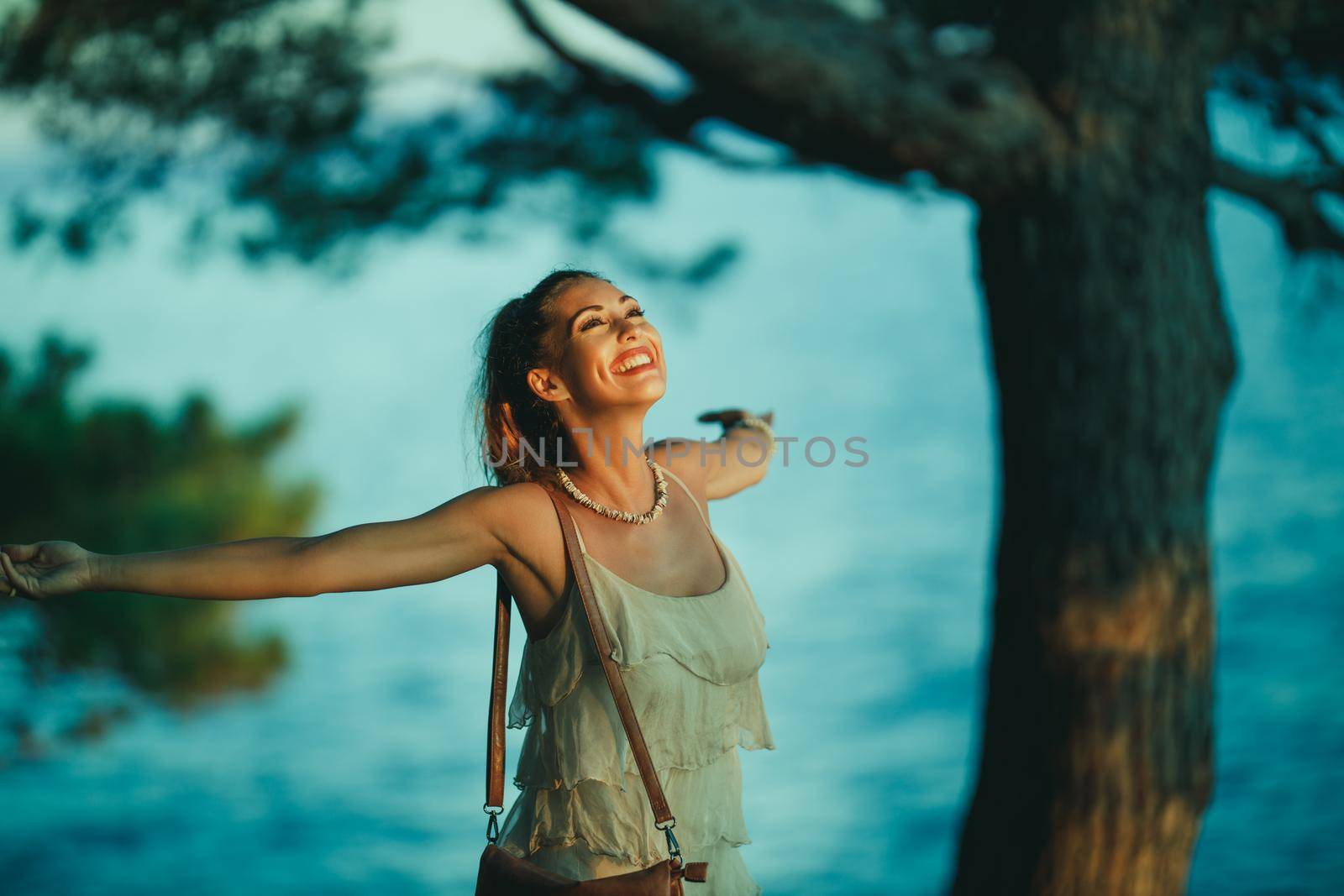 A cheerful young woman having fun on vacation and exploring Mediterranean seaside.