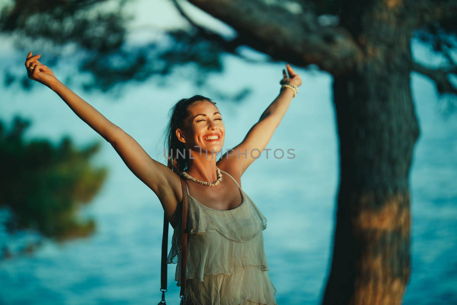 A cheerful young woman having fun on vacation and exploring Mediterranean seaside.