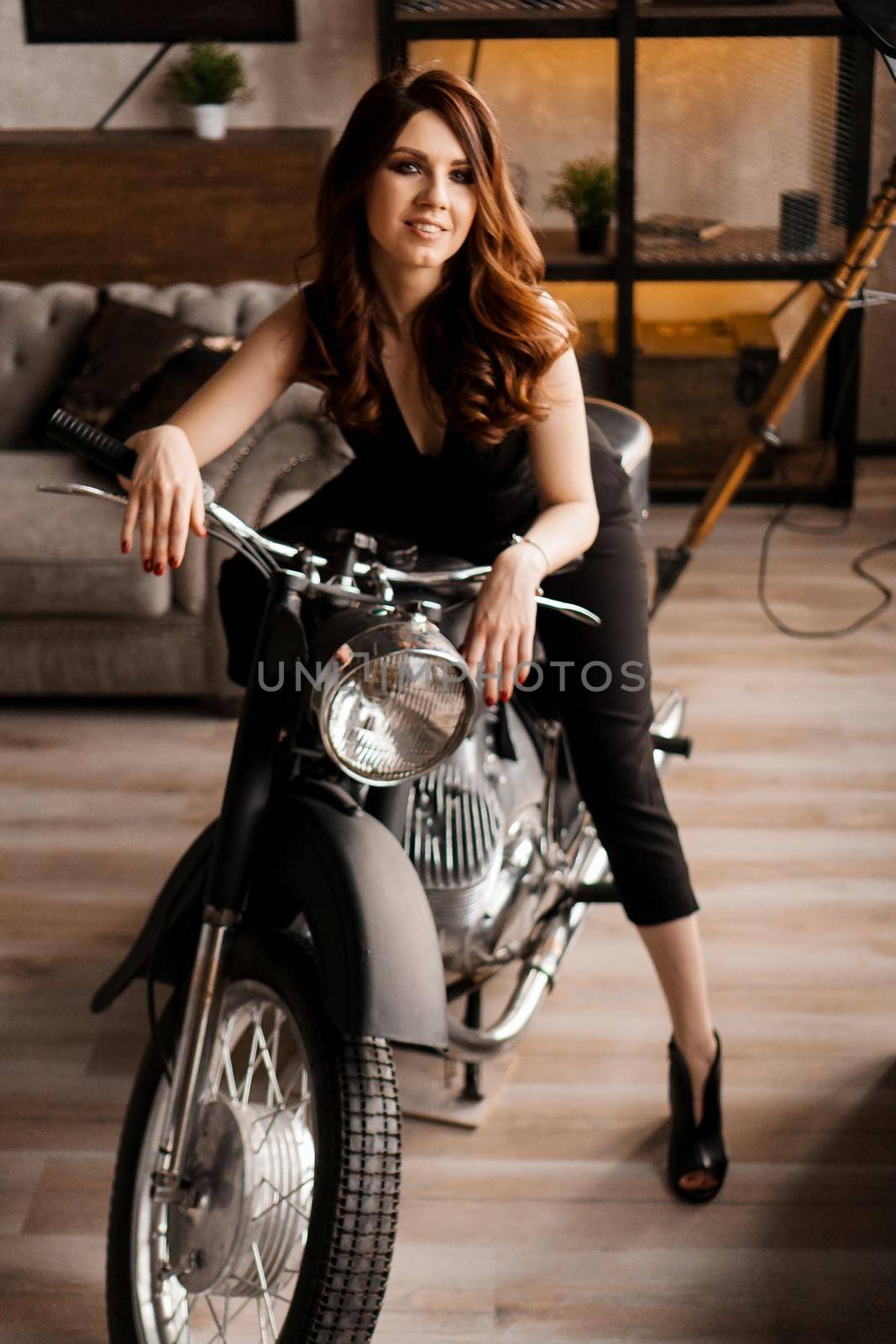 Young woman with motorcycle in studio by natali_brill