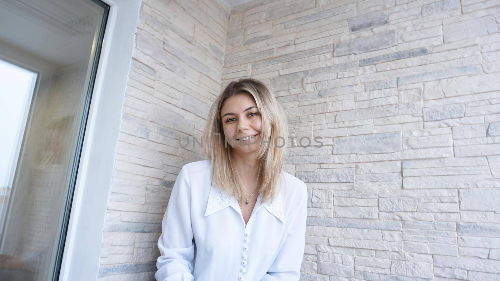 Portrait of attractive young european businesswoman on brick wall background. Success concept