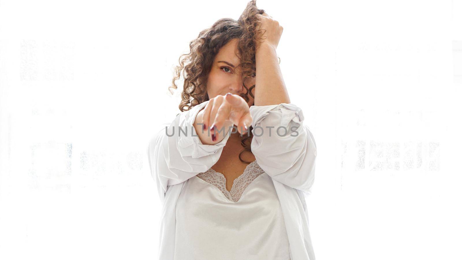 Sexy young woman in white shirt in bedroom - white light from window by natali_brill