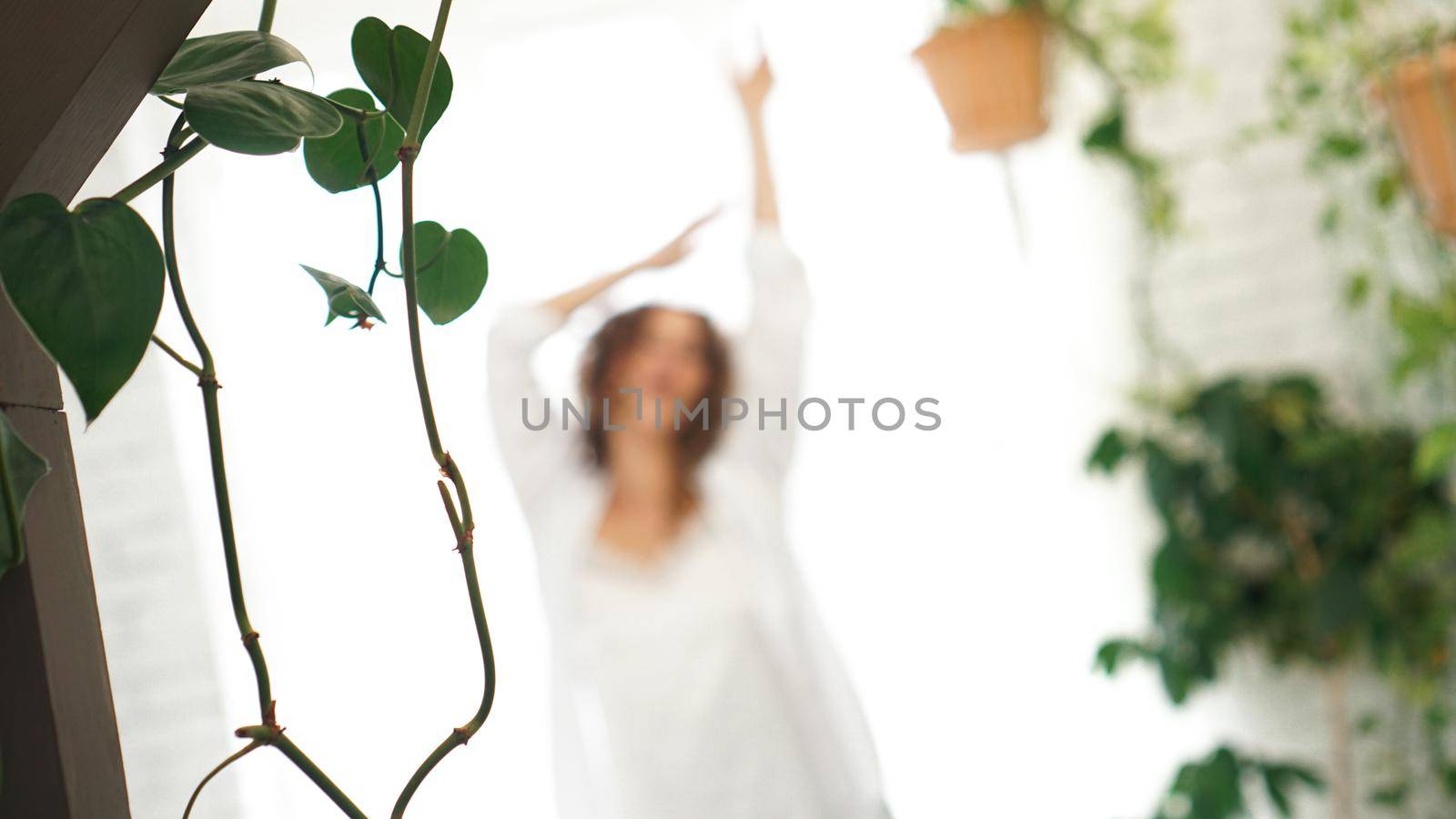 Beautiful woman after waking up in the morning. Healthy and happiness concept. Happily with a smile. Photo out of focus. Blurred background for text