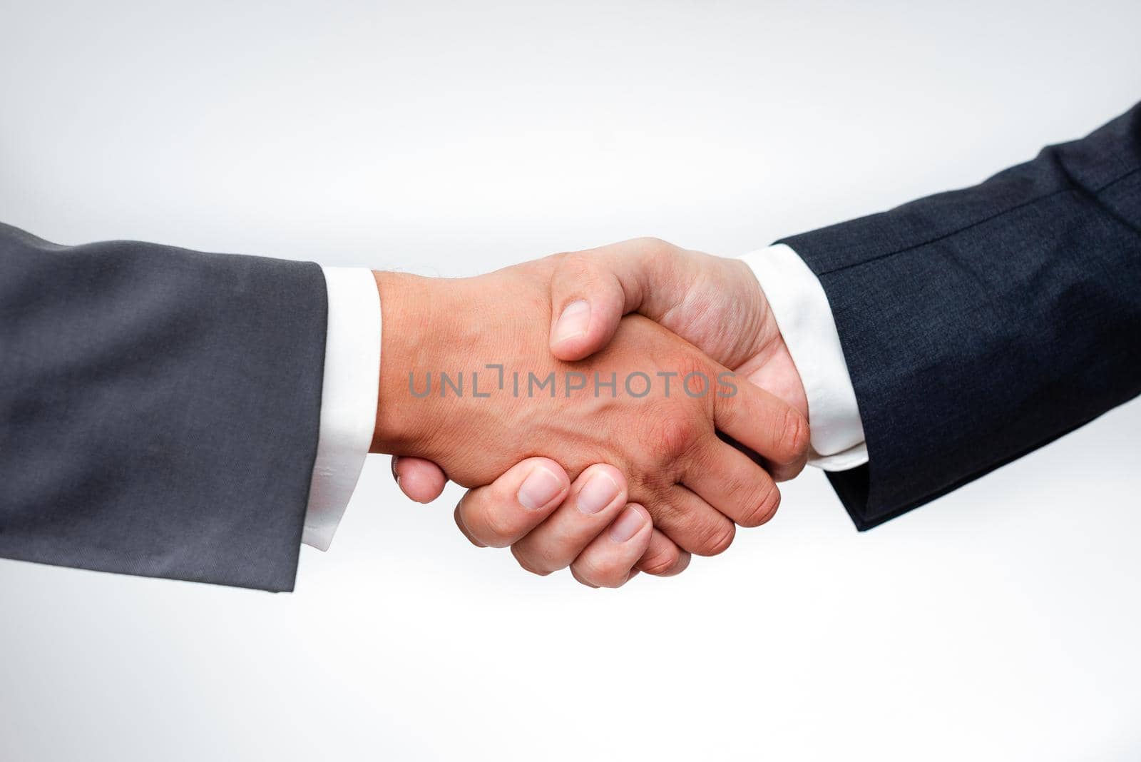 Two Professional Well-Dressed Corporate Businessmen Handshake Indoors