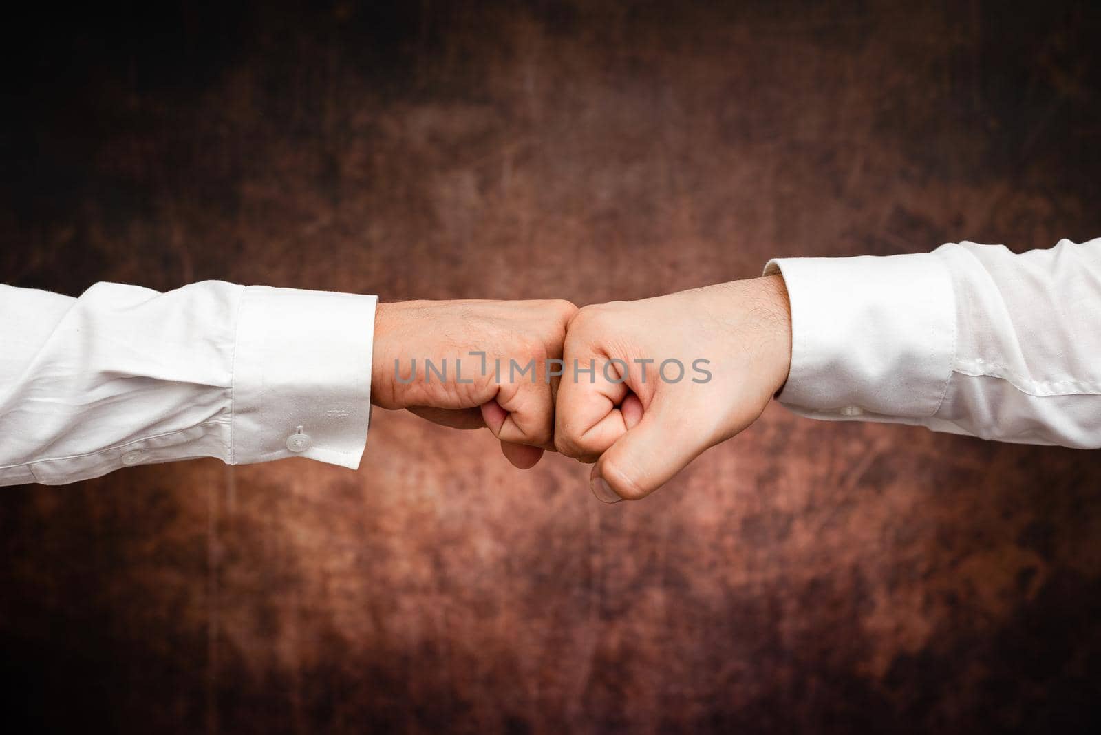 Corporate Businessmen Handshake Indoors.Two People Professionally Well Dressed Gesturing Togetherness.Working Colleague Partners Sign Deal In Agreement To Contract by nialowwa