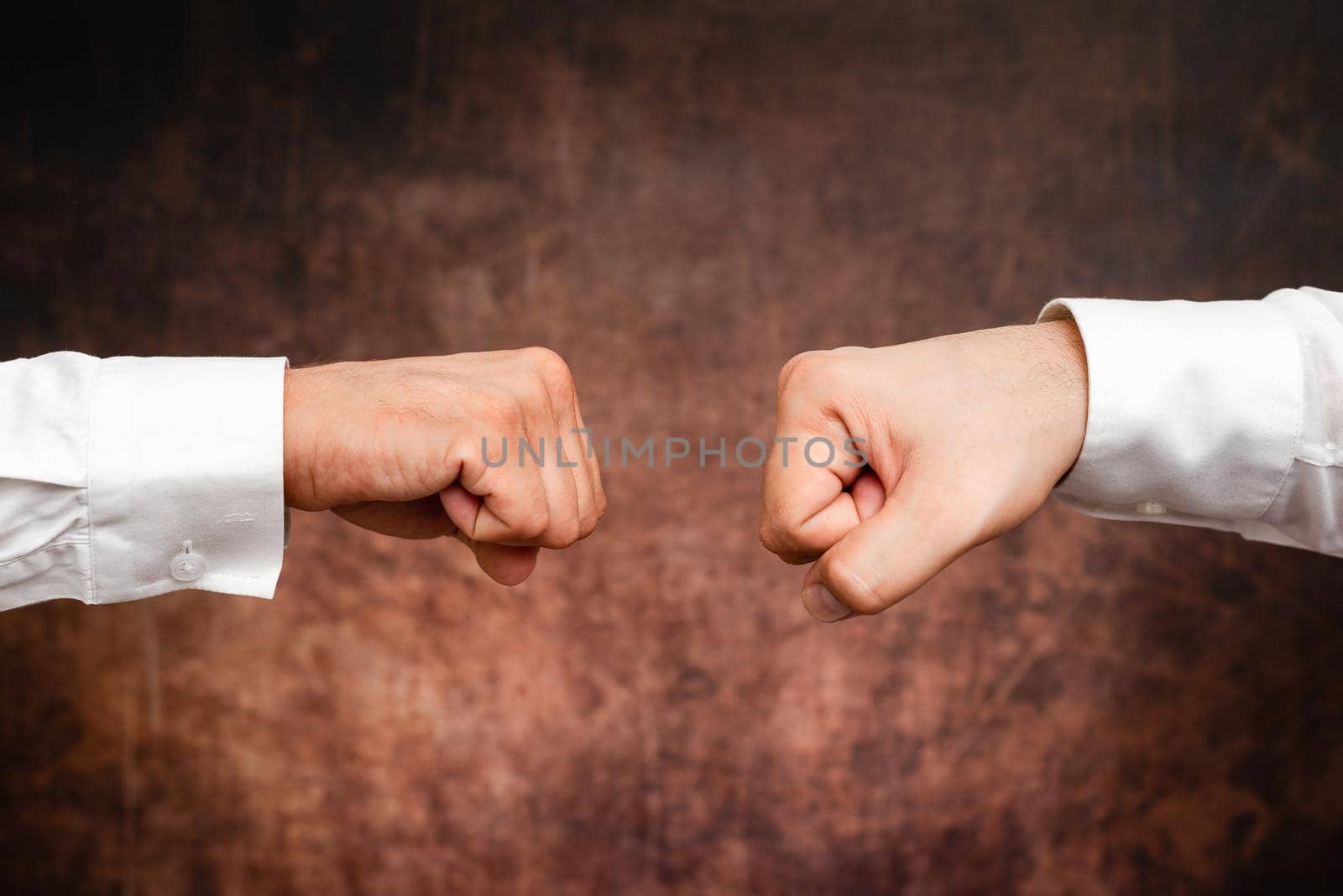 Corporate Businessmen Handshake Indoors.Two People Professionally Well Dressed Gesturing Togetherness.Working Colleague Partners Sign Deal In Agreement To Contract by nialowwa