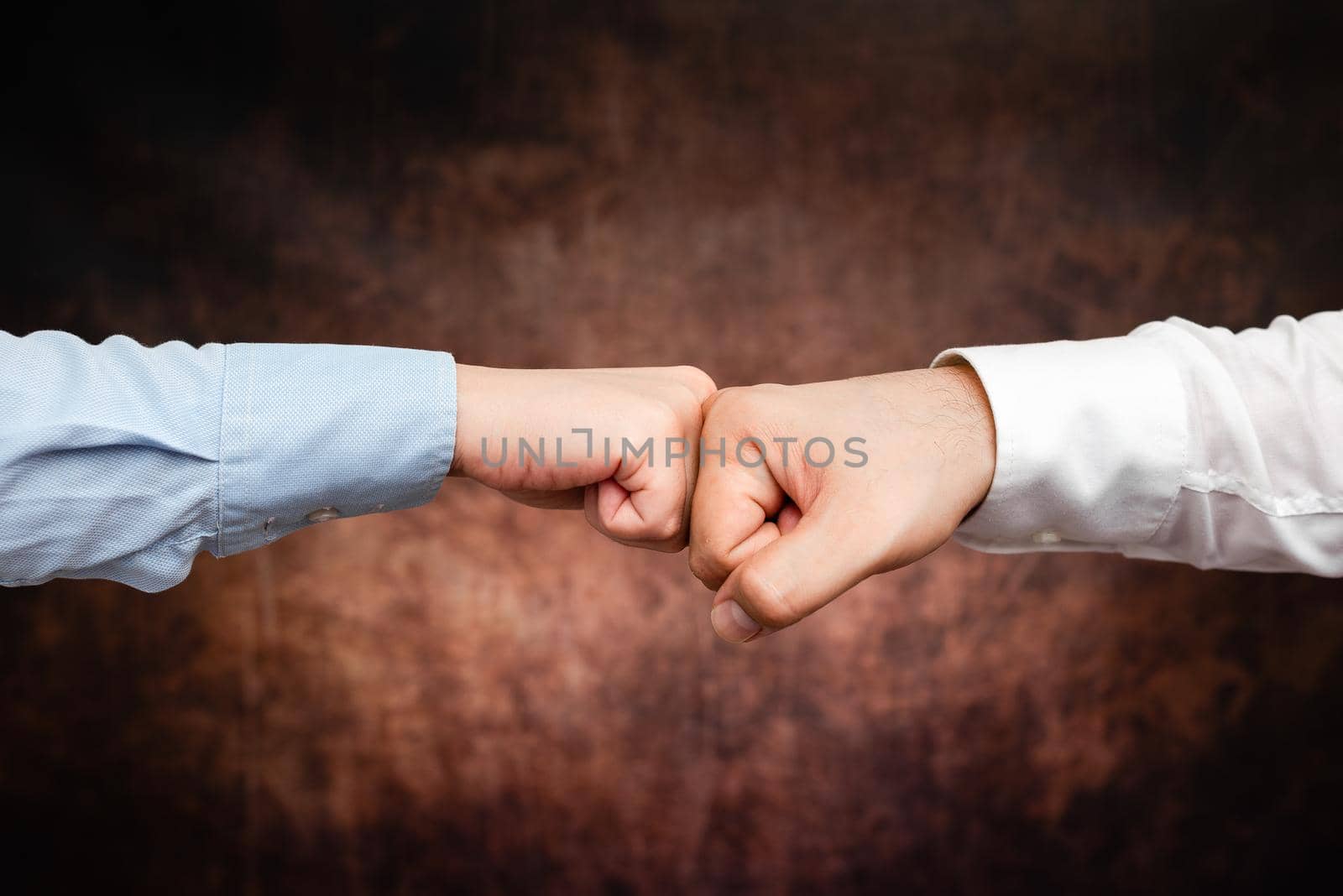 Corporate Businessmen Handshake Indoors.Two People Professionally Well Dressed Gesturing Togetherness.Working Colleague Partners Sign Deal In Agreement To Contract by nialowwa