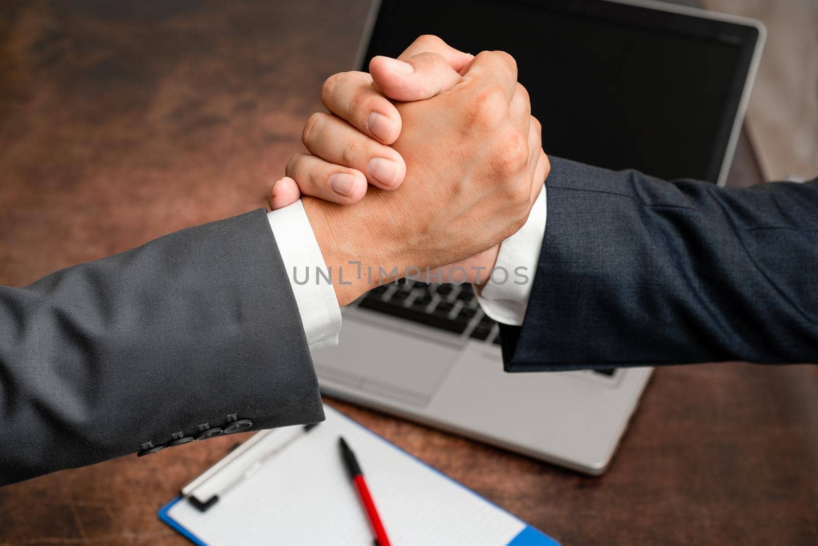 Two Professional Well-Dressed Corporate Businessmen Handshake Indoors