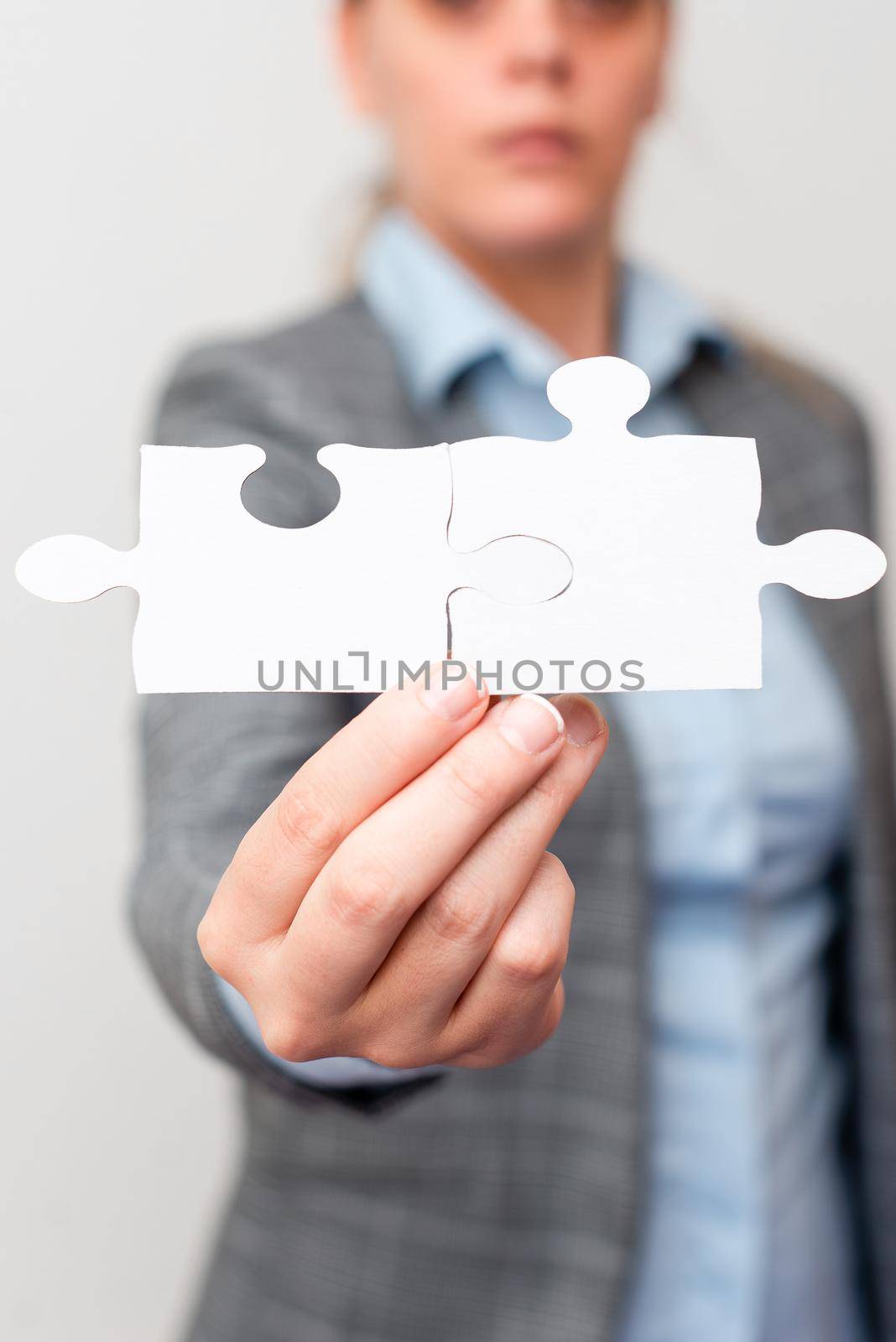 Welldressed Business Woman Holding Two Pieces Of Jigsaw Puzzle, Professional Adult Women Resolving Missing Ideas, Strategy For New Ideas by nialowwa