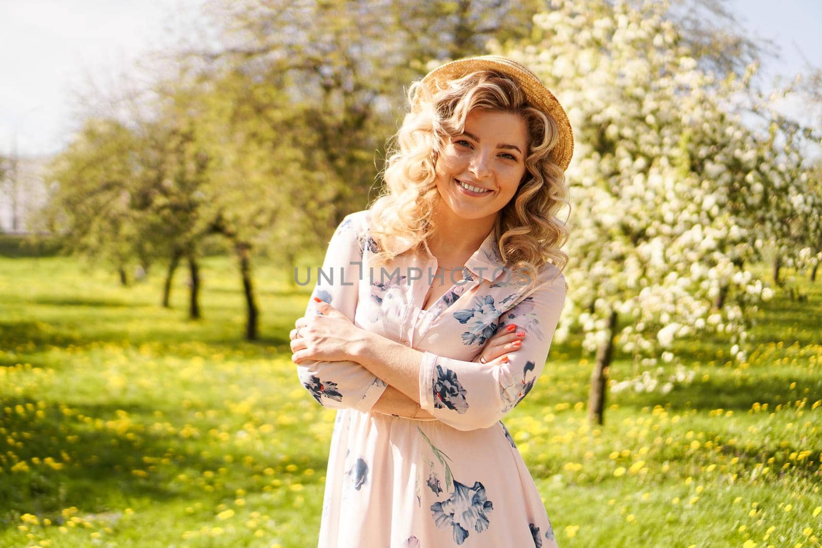 Smiling summer woman with straw hat in park by natali_brill