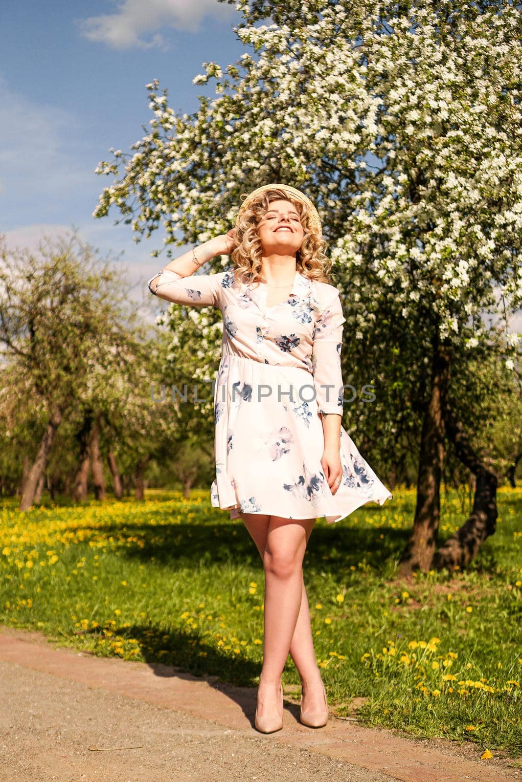 Smiling summer woman with straw hat in park by natali_brill