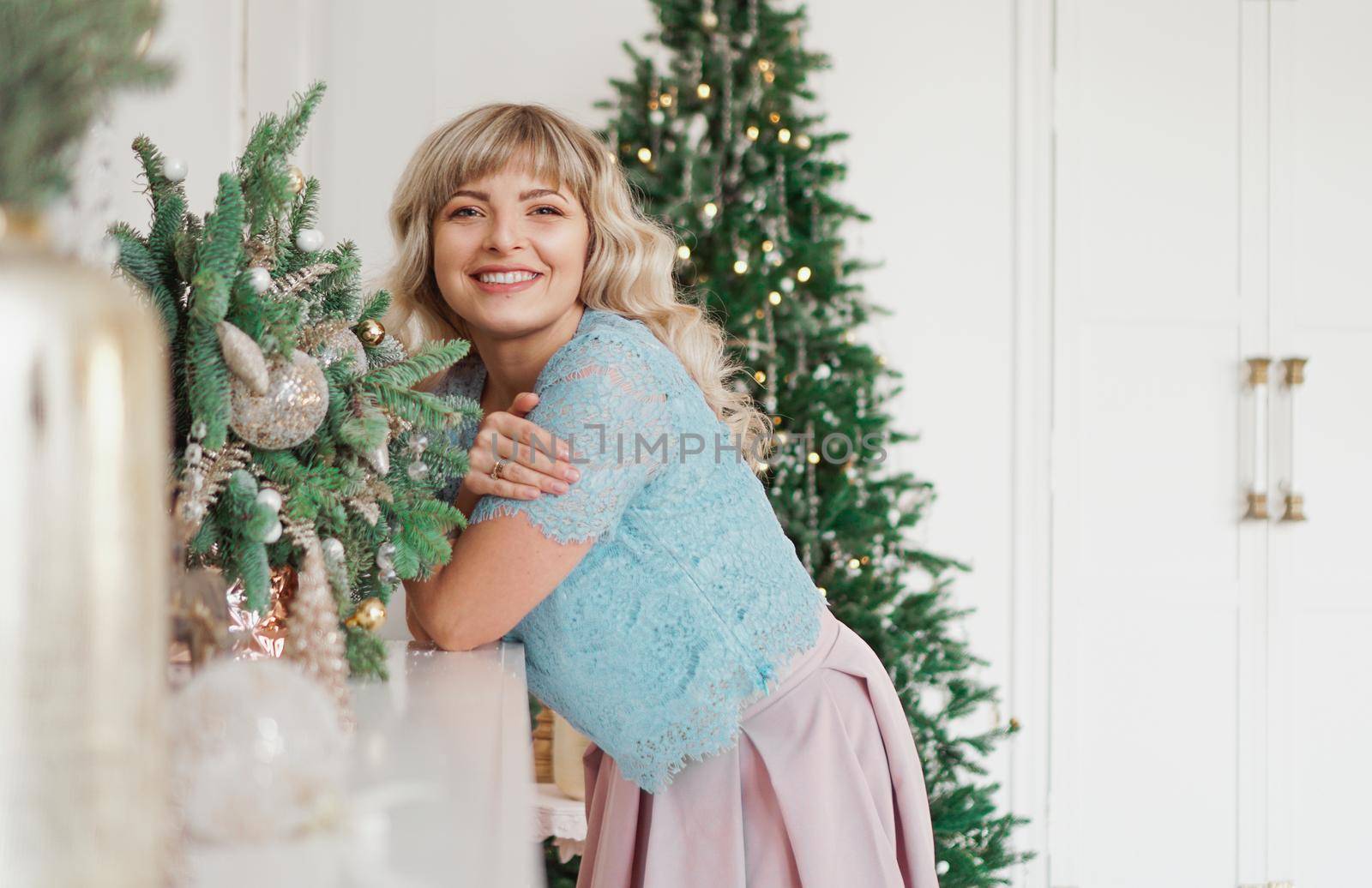 Charming Girl with Beautiful Make-up on Face in gold and white interior. Christmas Holidays, Merry Celebration with the Family