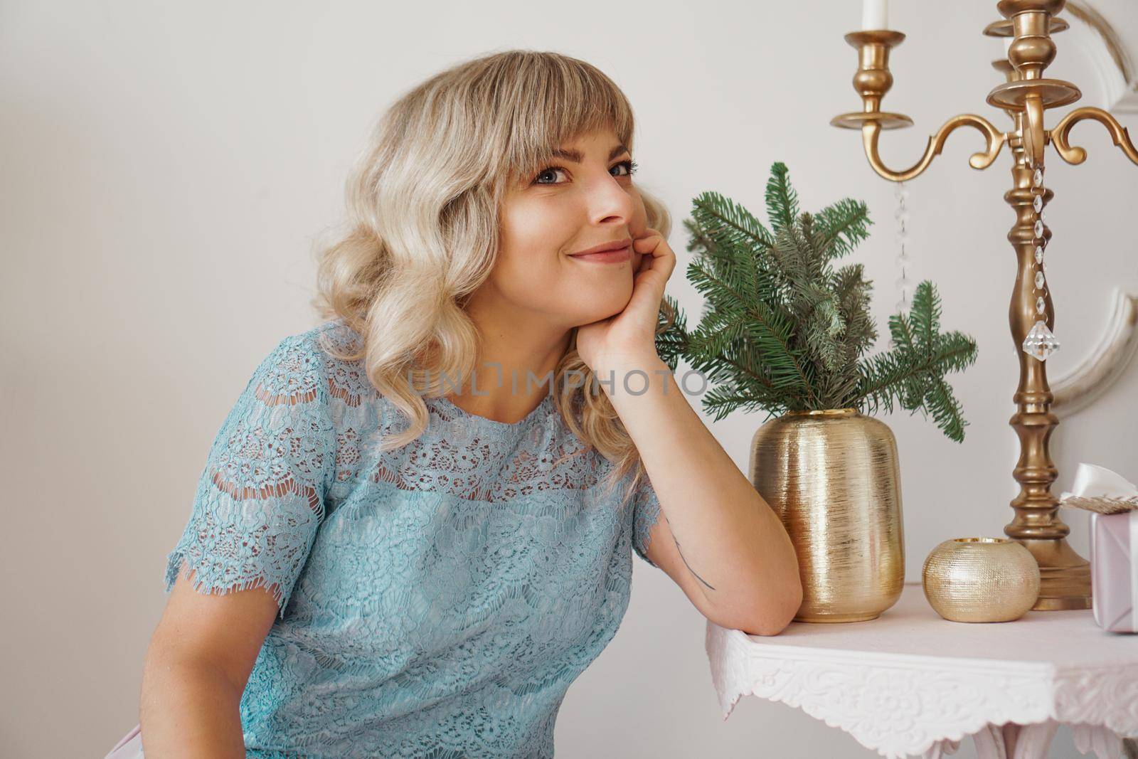 Image of dreaming woman in gold and white interior. Christmas Holidays, New year