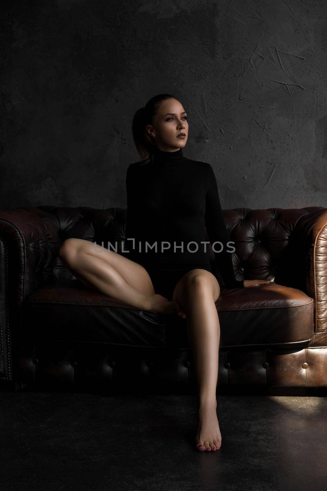 Beautiful sexy woman on leather sofa by natali_brill