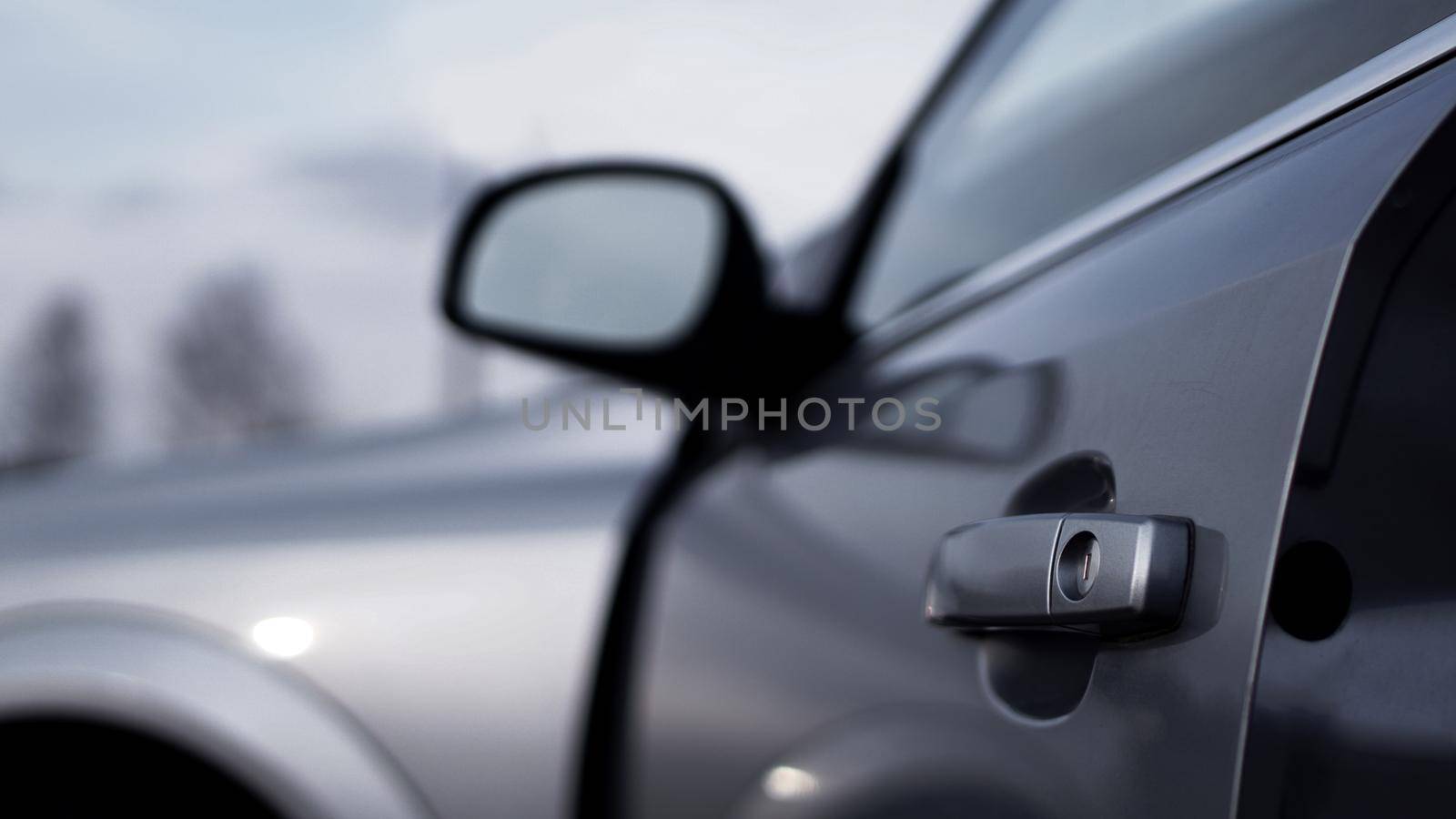 Color horizontal shot of closeup a dark silver car door handle