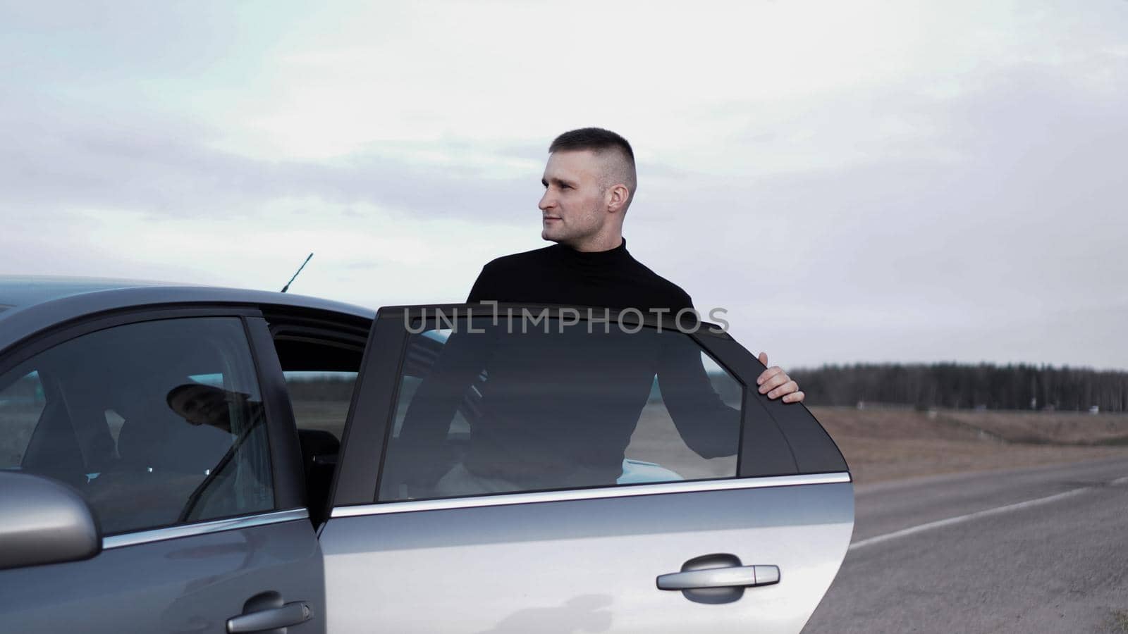 Handsome young man near the car. Luxury life.