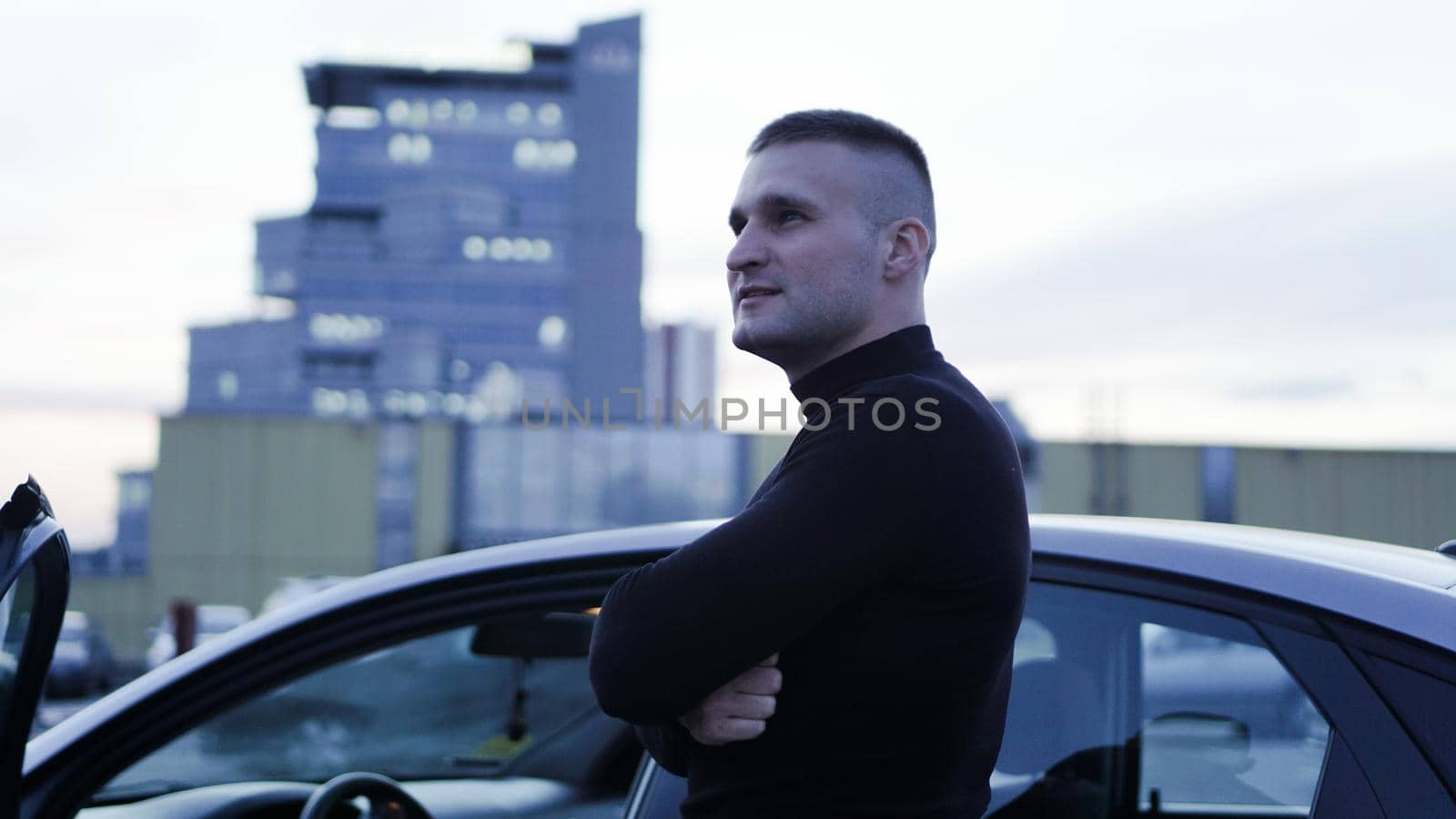 Handsome businessman near his car in the city