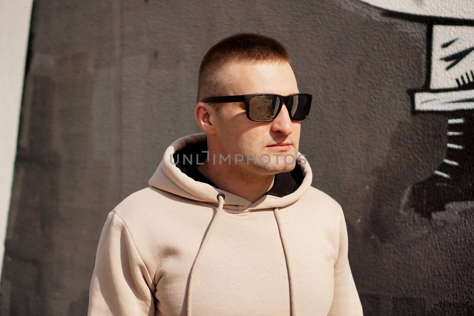 Hipster man in the street in summer day. Young man in sunglasses. Lifestyle photo