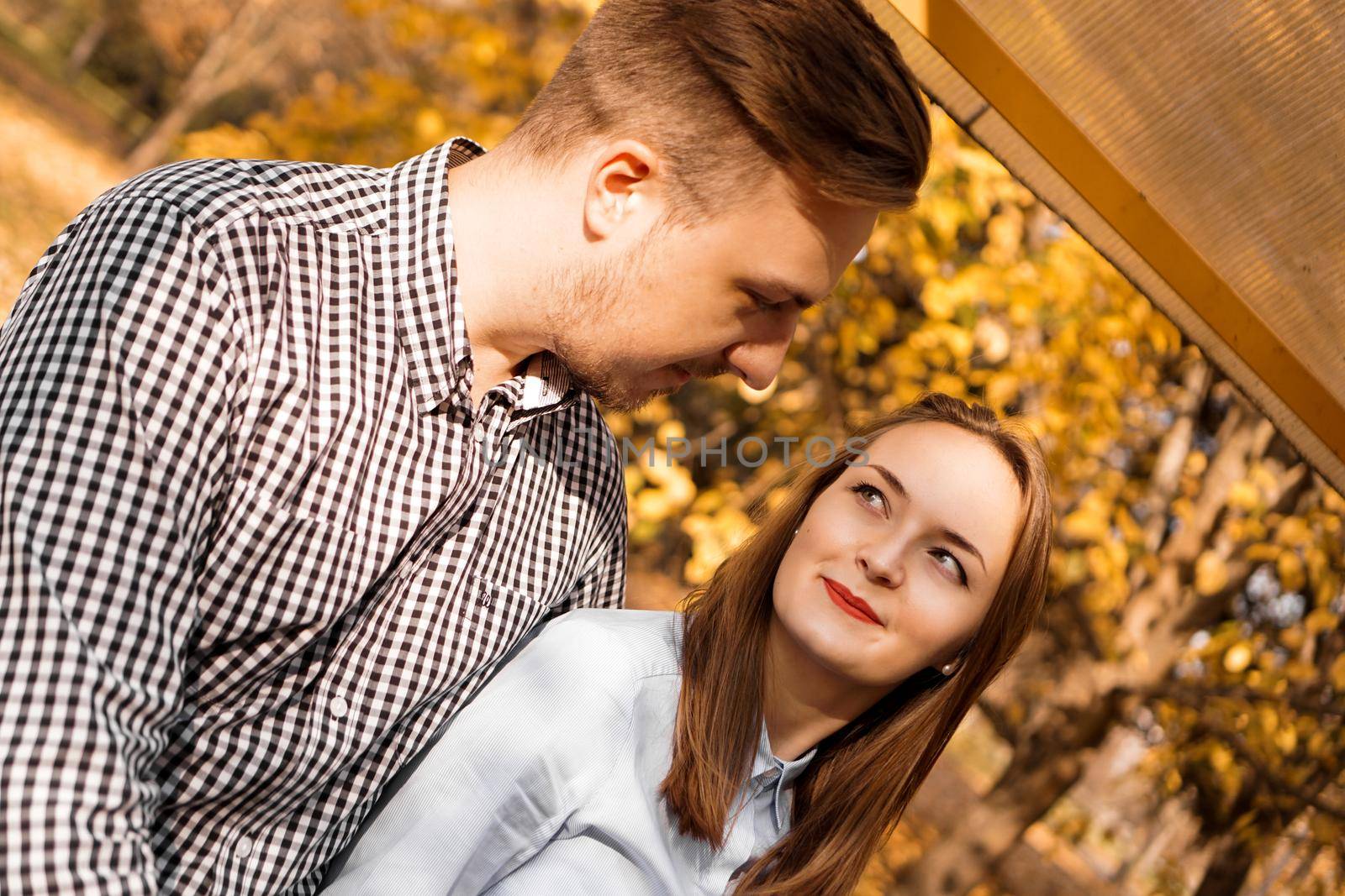 Romantic couple in the autumn park - sunny day - love, relationship and dating concept