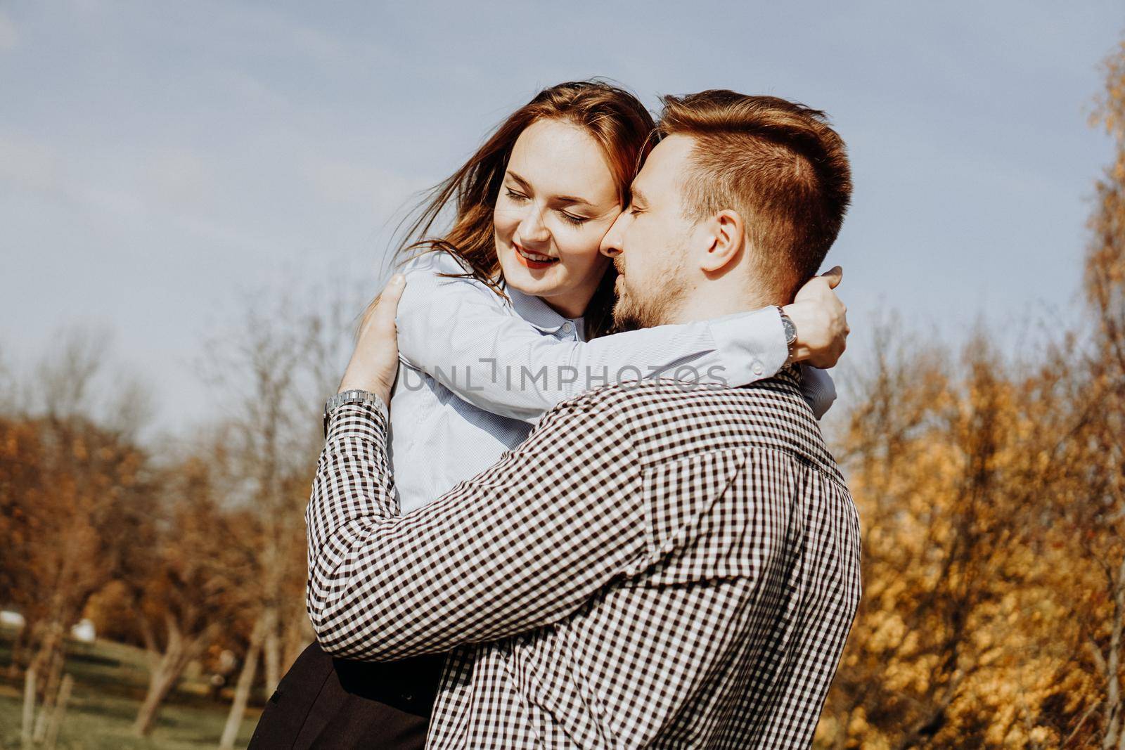 Romantic couple in the autumn park - love, relationship and dating concept by natali_brill