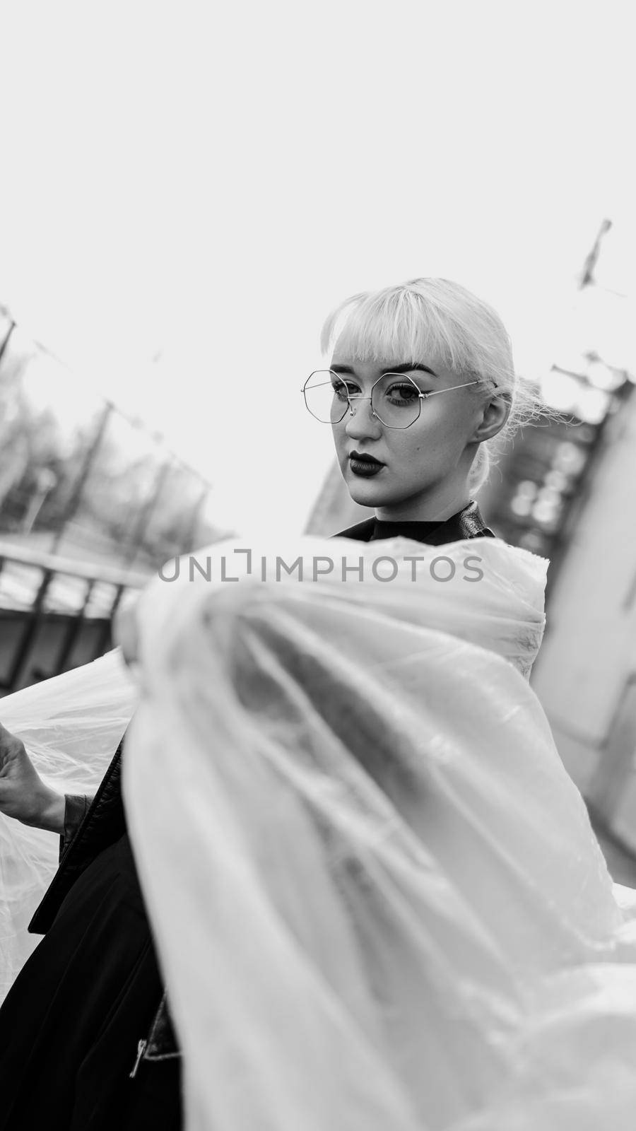 Ecology concept. Girl with plastic wrap. City Style. Urban photo. Black and white