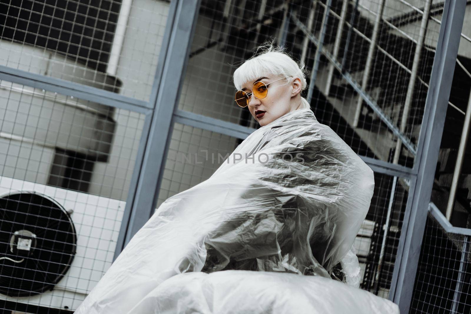 Ecology concept. Girl with plastic wrap. City Style. Urban photo