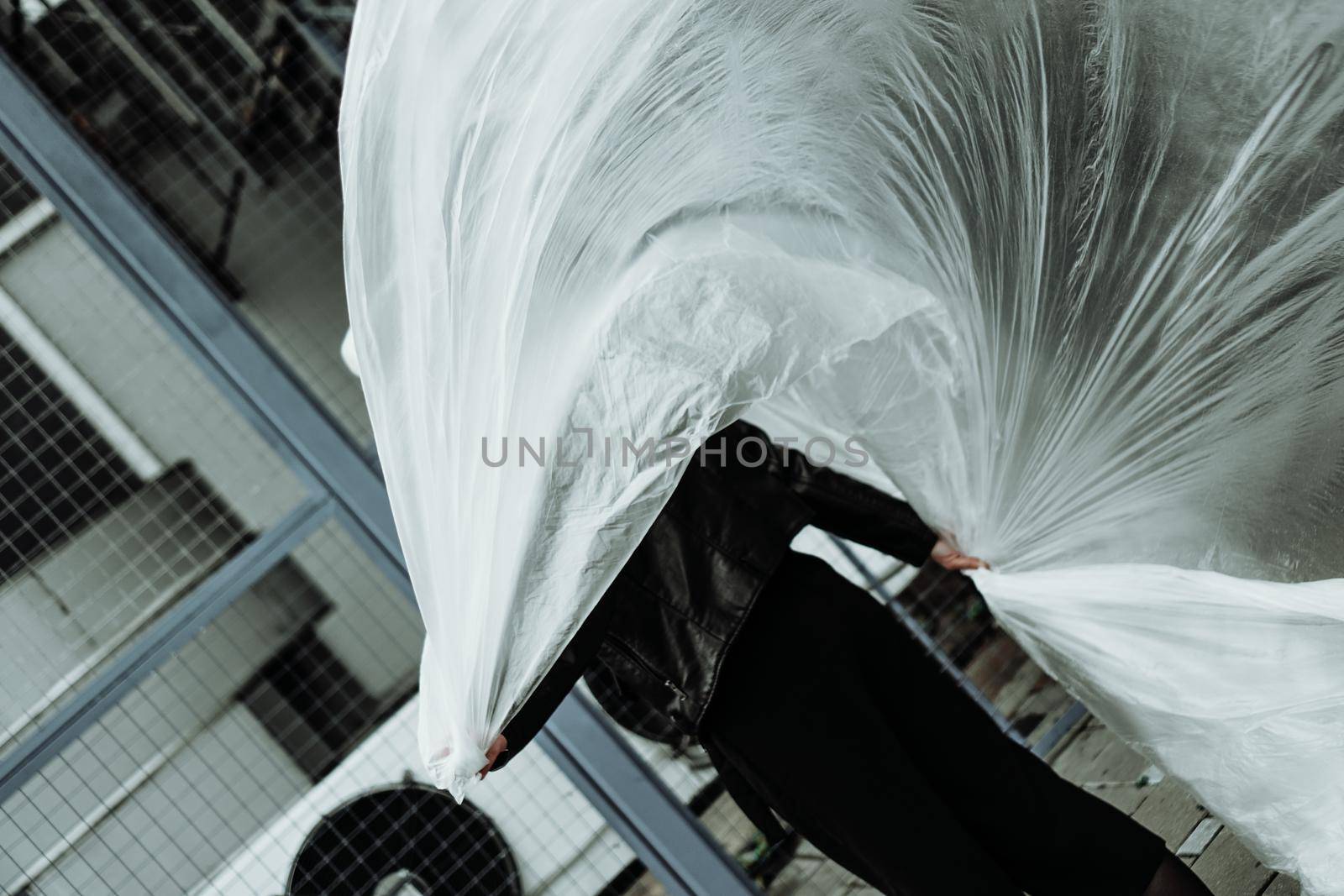 Ecology concept. Girl with plastic wrap. City Style. Urban photo