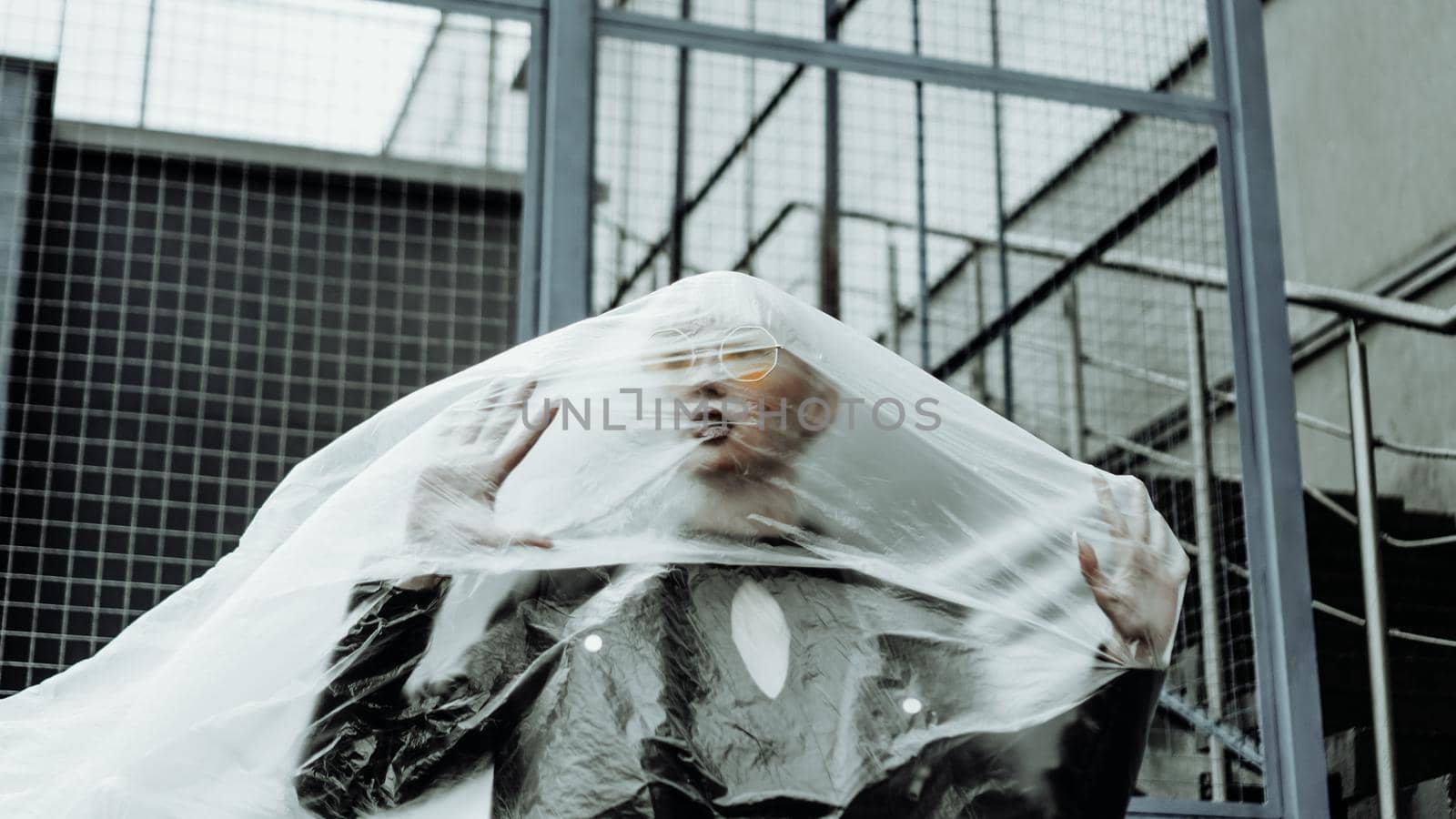 Ecology concept. Girl with plastic wrap. City Style. Urban photo