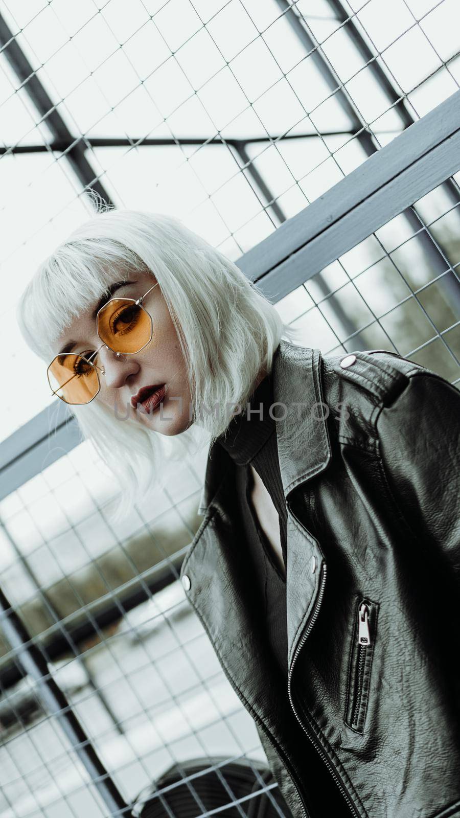 Portrait of woman with white hair and glasses. Modern urban style - vertical photo