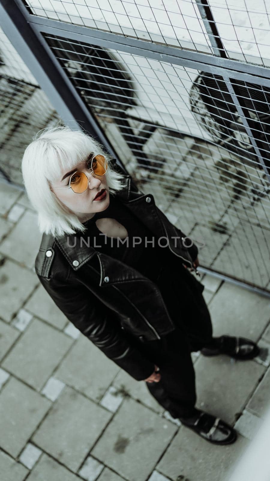 Portrait of woman with white hair and glasses. Modern urban style - vertical photo