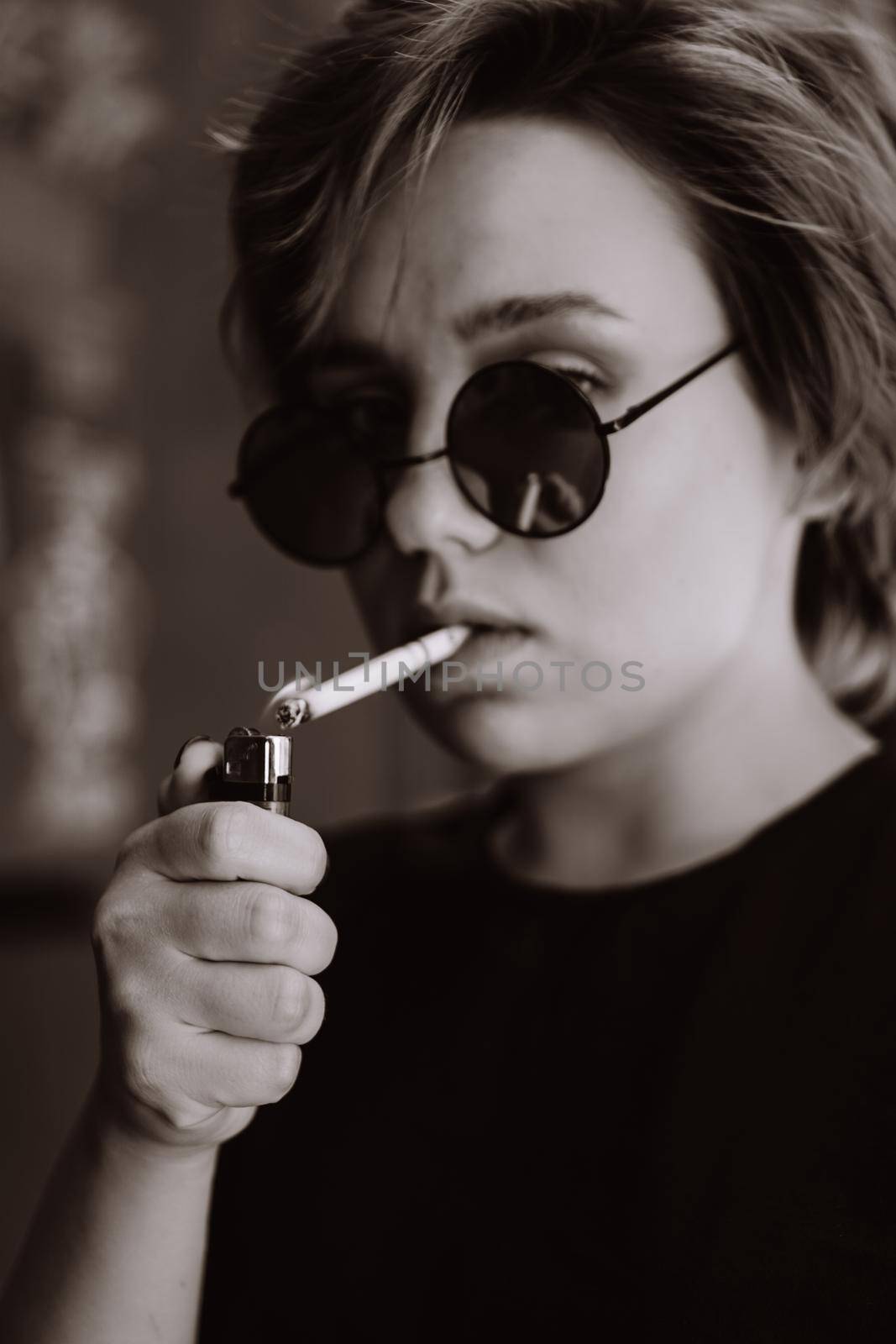 Millennial girl with short hair and mirror sunglasses smoking cigarette by natali_brill