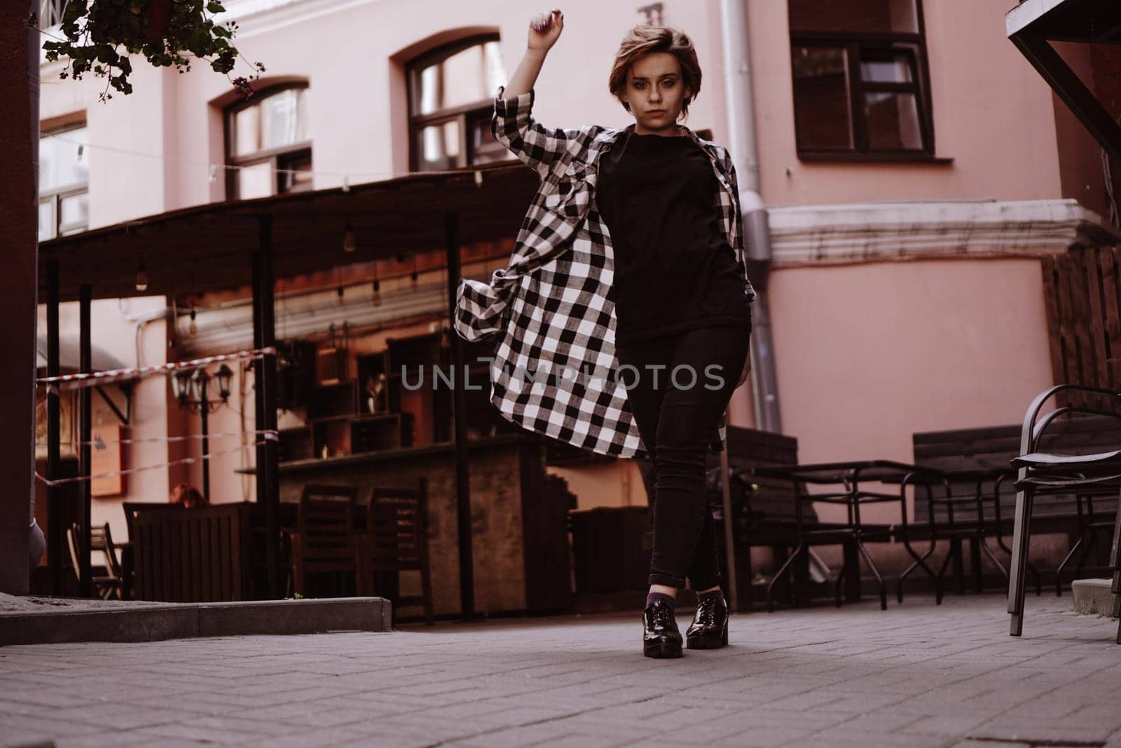 Beautiful young woman with short red hair in plaid shirt by natali_brill