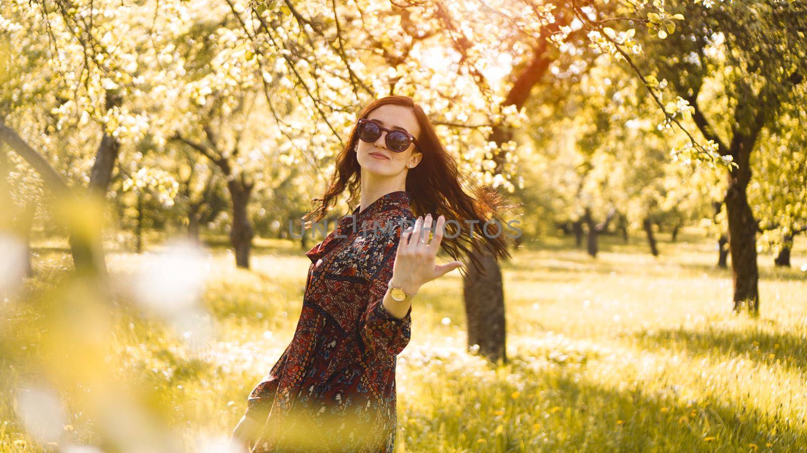 Smiling summer woman with sunglasses. Beautiful Young Woman Outdoor. Enjoy Nature. Healthy Smiling Girl in the Spring Park. Sunny day