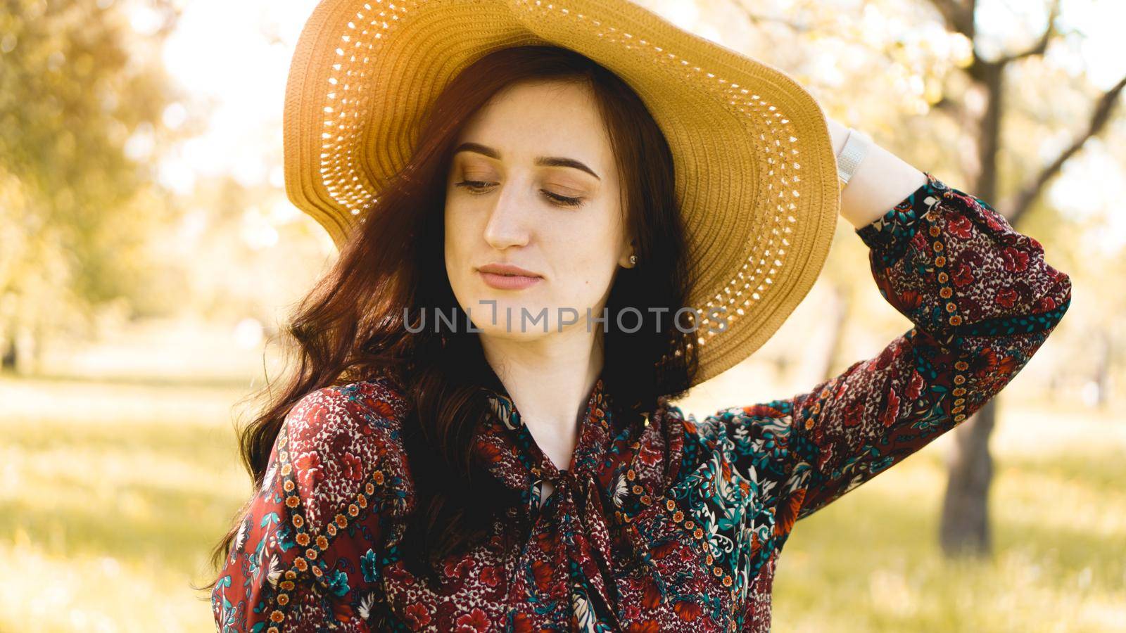 Summer portrait, beautiful young woman wearing straw hat at sunset time by natali_brill