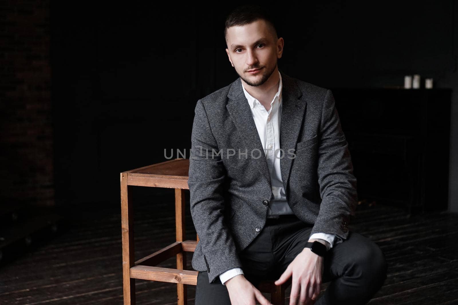 Portrait of a young handsome elegant man on dark background by natali_brill