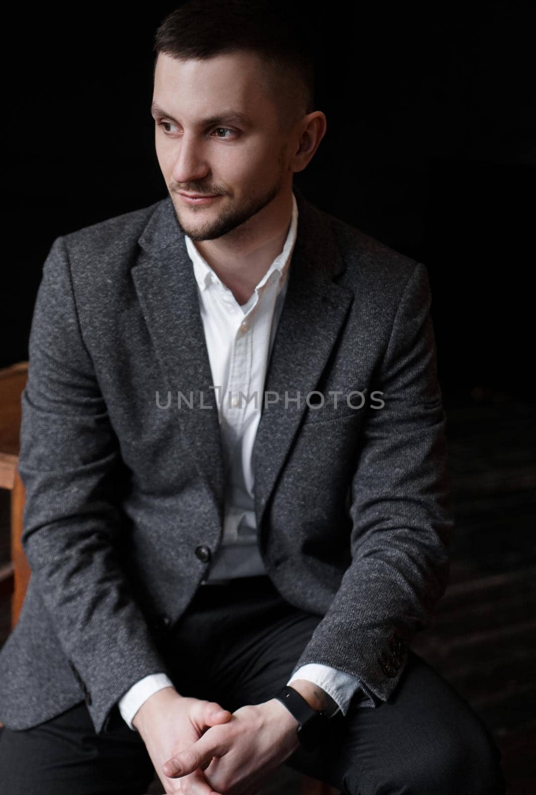 Portrait of a young handsome elegant man on dark background by natali_brill