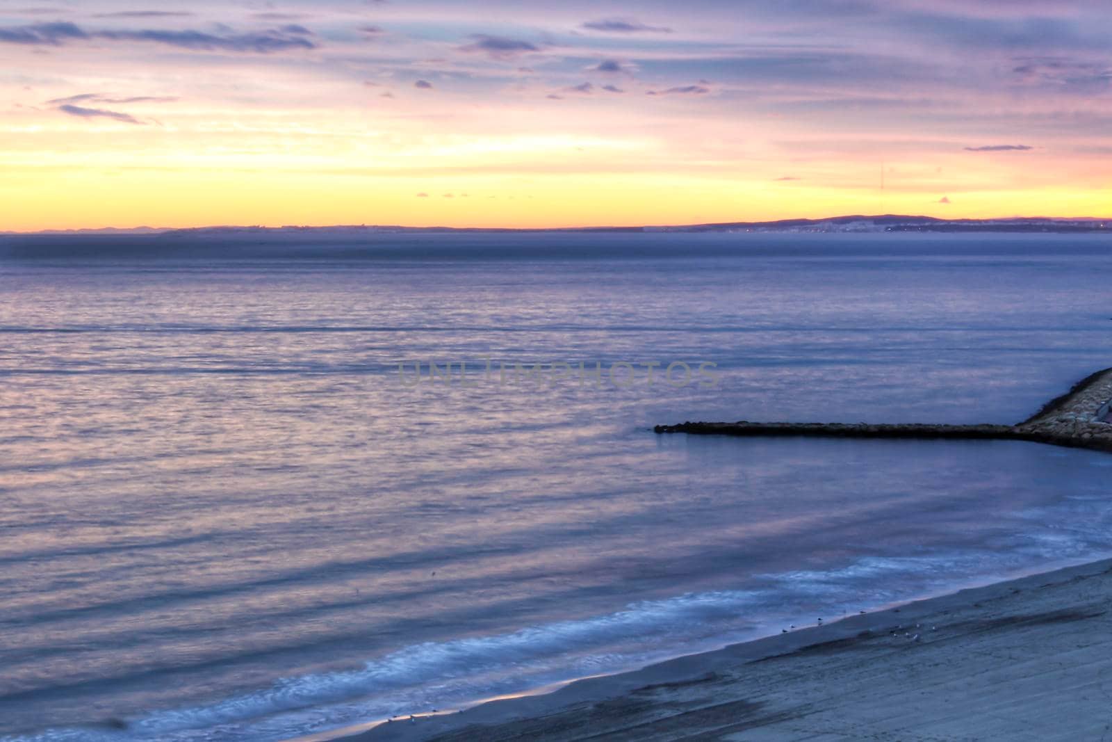 Spectacular and colorful sunset in the bay of Santa Pola, Alicante, Spain in autumn