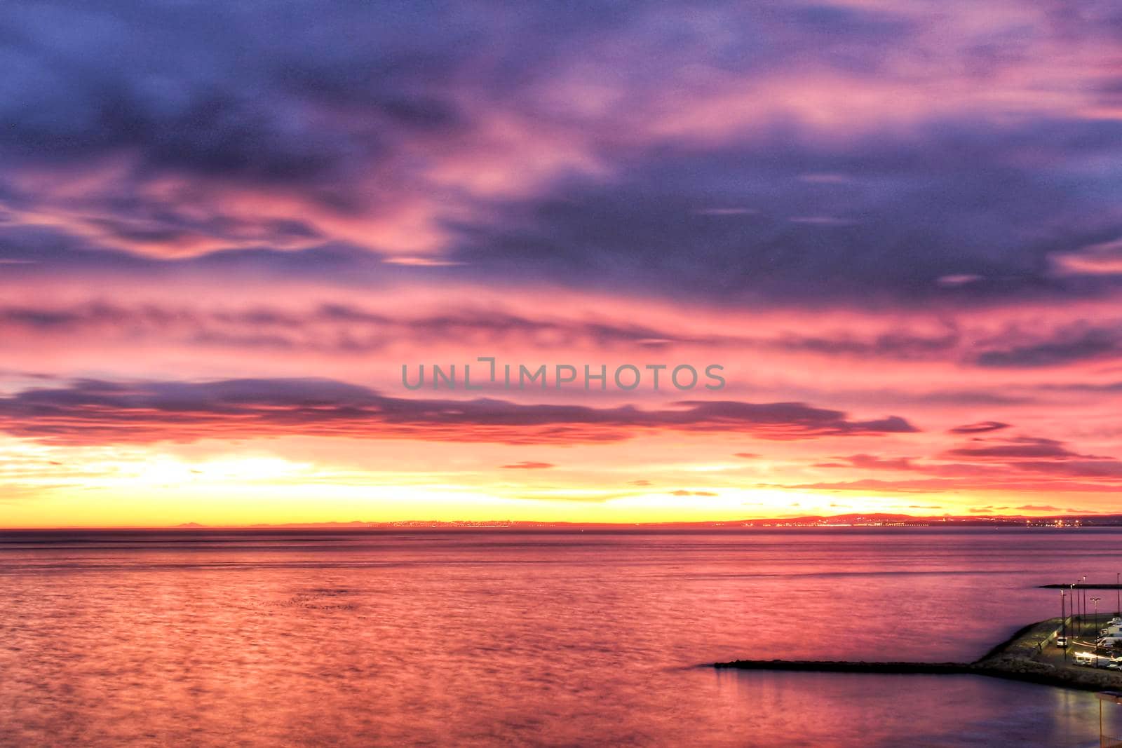 Spectacular and colorful sunset in the bay of Santa Pola, Alicante, Spain in autumn